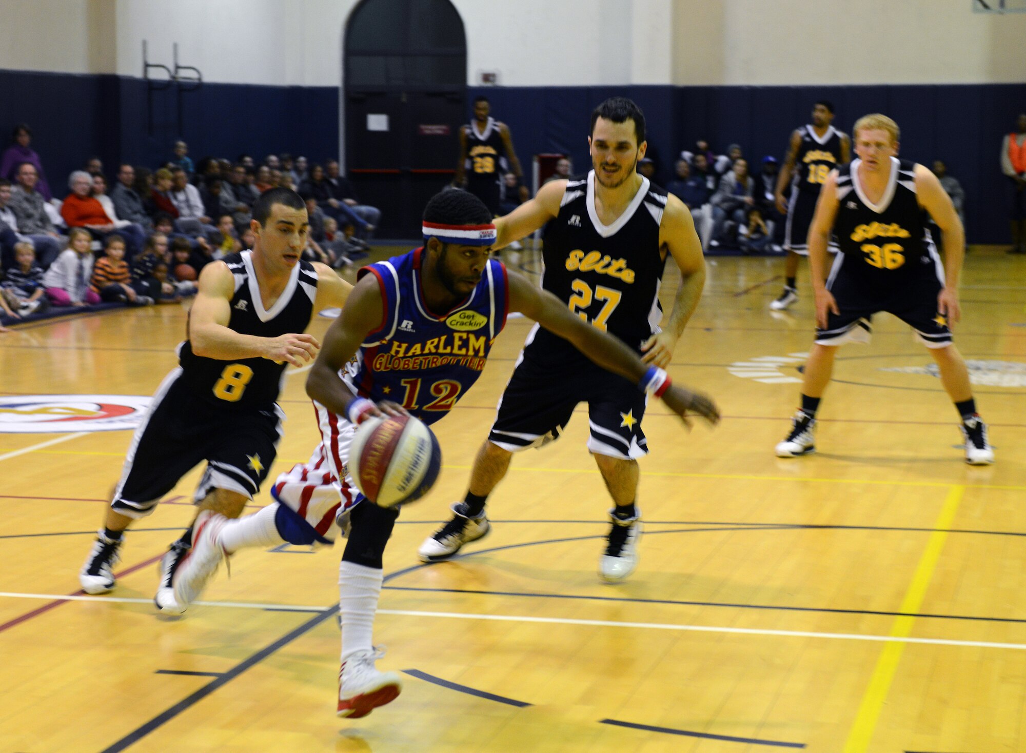 Ant, Harlem Globetrotters guard, dribbles down the court during the 12th Annual Harlem Globetrotters Holiday Tour Dec. 10, 2013, at Aviano Air Base, Italy. As part of their 2013-2014 “You Make the Rules” tour schedule, the team added 12 games at U.S. military installations in the United Kingdom, Germany, Italy, Greece and Spain. (U.S. Air Force photo/Airman Ryan Conroy)