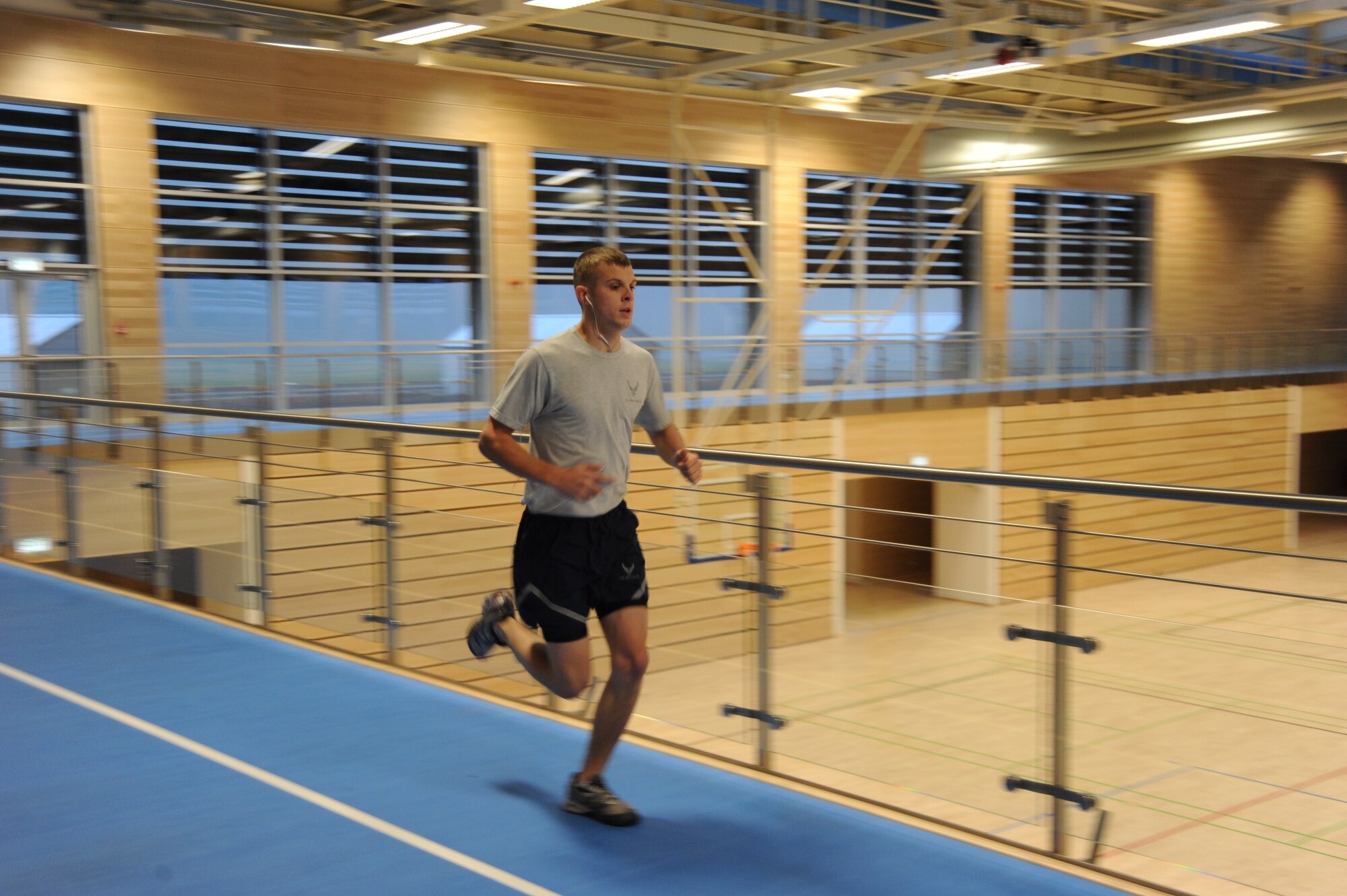 SPANGDAHLEM AIR BASE, Germany --- Senior Airman Joseph Morgridge, a crew chief with 52nd Aircraft Maintenance Squadron, runs around an indoor track during a physical fitness assessment at the new fitness center Dec. 12, 2013. The fitness center is open for physical training assessments. (U.S. Air Force photo by Airman 1st Class Dylan Nuckolls / Released)