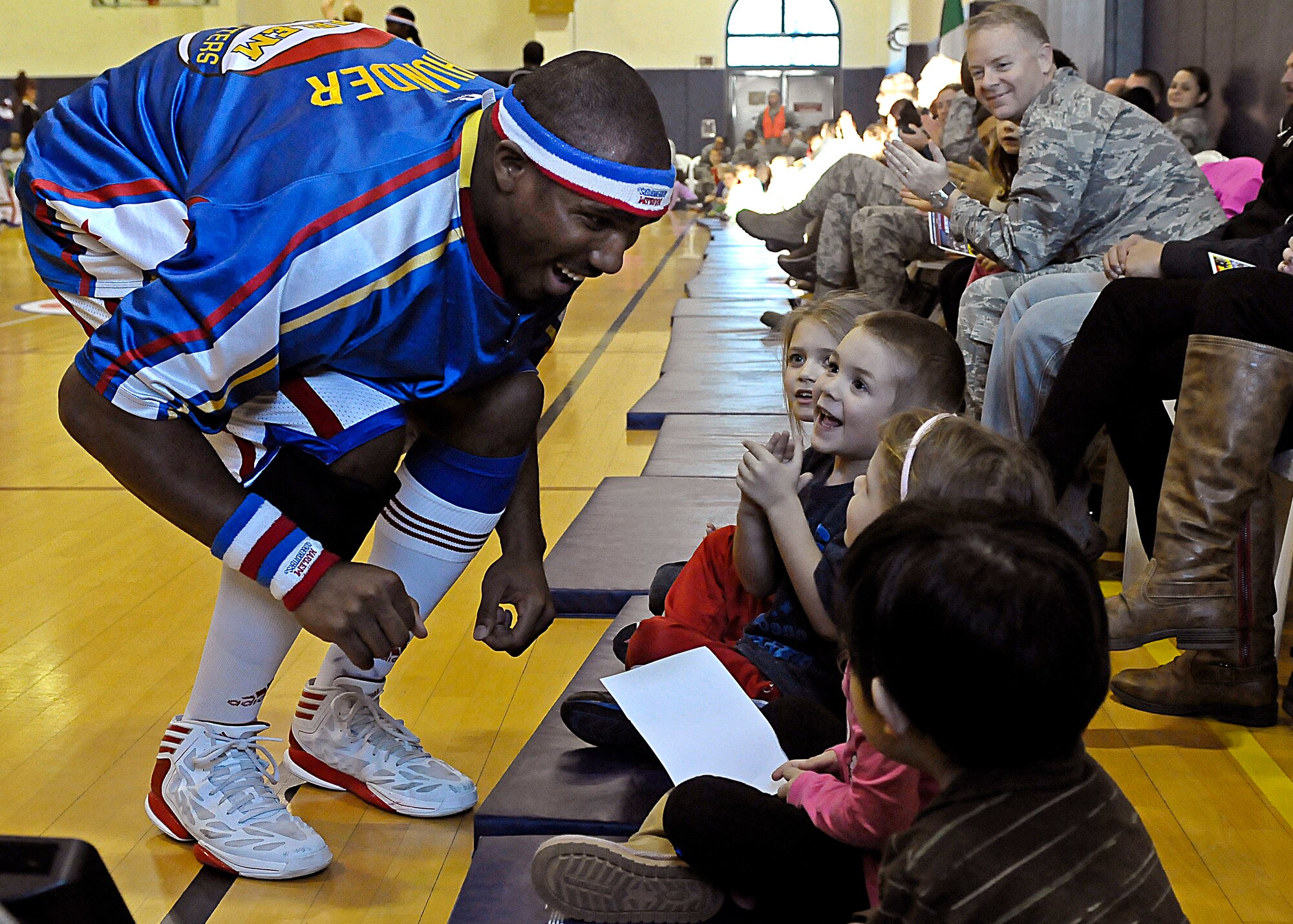Thunder, Harlem Globetrotters forward, interacts with children during the 12th Annual Harlem Globetrotters Holiday Tour Dec. 10, 2013, at Aviano Air Base, Italy. As part of their 2013-2014 “You Make the Rules” tour schedule, the team added 12 games at U.S. military installations in the United Kingdom, Germany, Italy, Greece and Spain. (U.S. Air Force photo/Airman 1st Class Deana Heitzman)