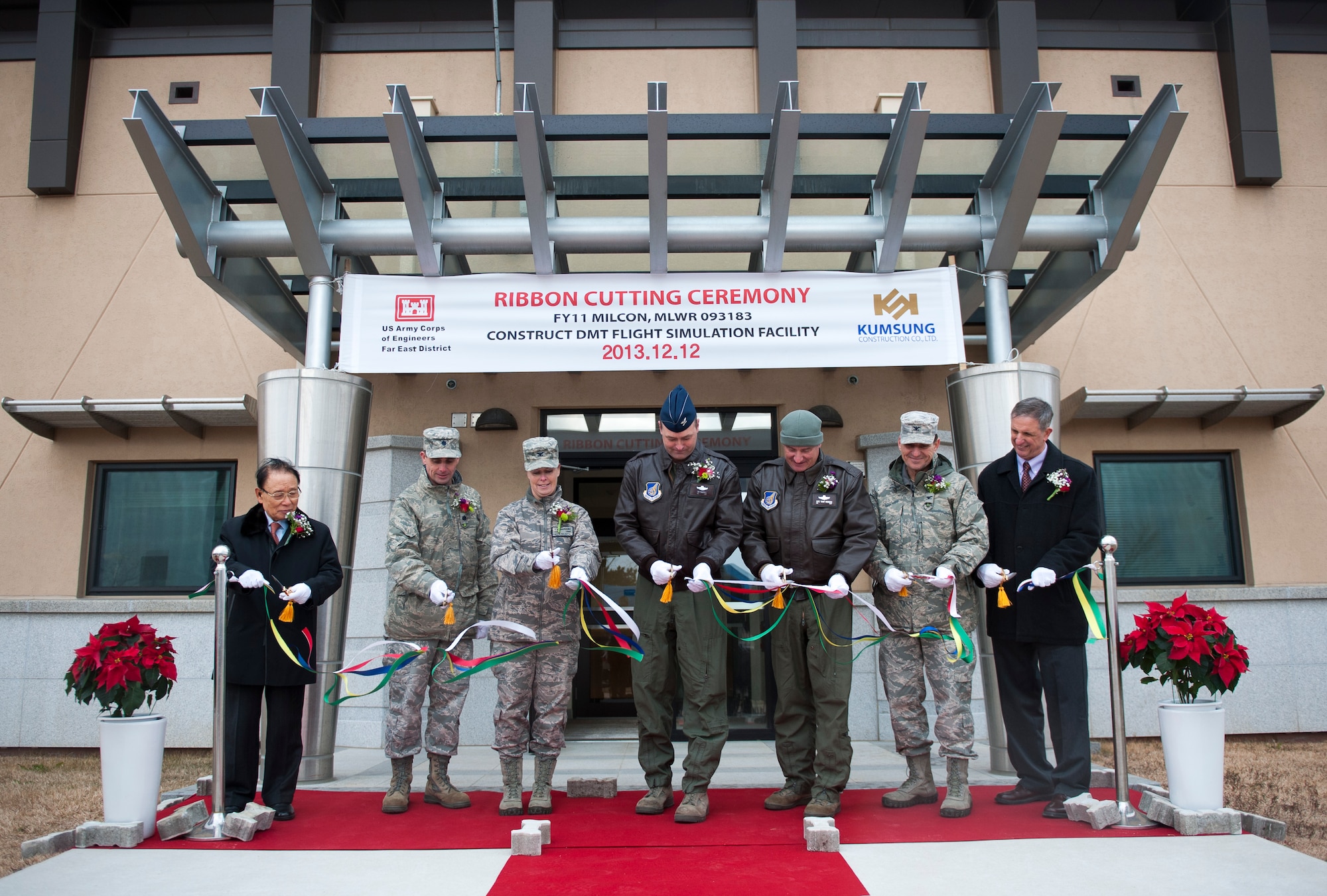 Wolf Pack leadership and Army Corp of Engineers Far East District cut the ribbon officially opening the F-16 Fighting Falcon training simulator at Kunsan Air Base, Republic of Korea, Dec. 12, 2013. The training center provides realistic, cost-effective training scenarios in a fiscally constrained environment. (U.S. Air Force photo by Senior Airman Armando A. Schwier-Morales/Released)