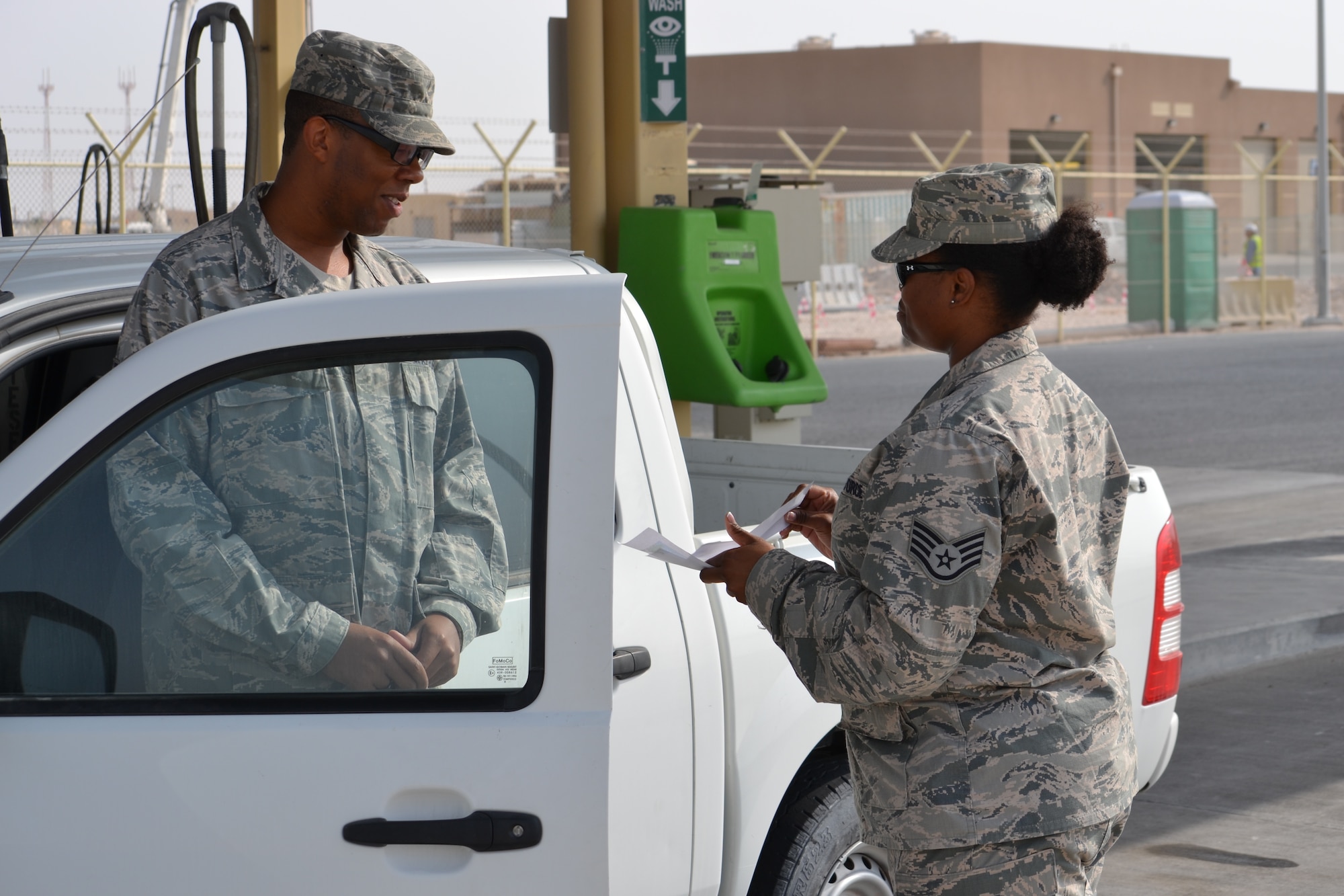 Staff Sgt. Danyette Washington, a contracting officer with the 379th Expeditionary Contracting who is deployed from RAF Lakenheath, United Kingdom and hails from New Orleans, L.A., pumps gas for Staff Sgt. Jamyal Lett, a chaplains assistant, as a random act of kindness during the 12 Days of Kindness endeavor initiated by the 379th Air Expeditionary Wing’s Helping Agencies Team.  This initiative’s goal is to perform random acts of kindness and inspire recipient Airmen to pay it forward.  Staff Sgt. Lett is deployed from Shaw Air Force Base and a native of Augusta, G.A. (U.S. Air Force photo/Maj. Nicole David)