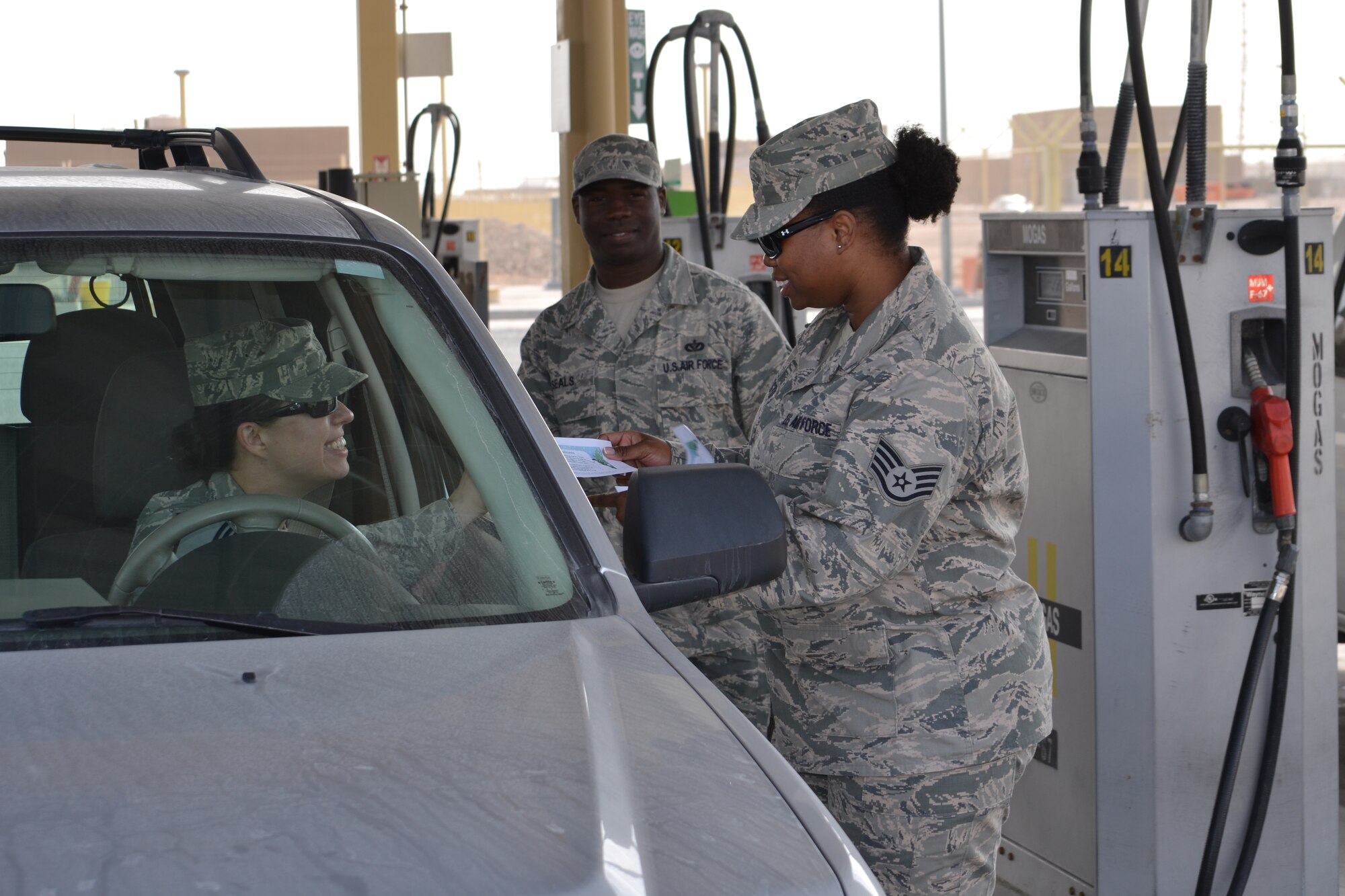 Staff Sgt. Danyette Washington, a contracting officer, and Technical Sgt. Justin Seals, a native of Vidalia L.A. and deployed from Ramstein  Air Base, Germany, pump gas as a random act of kindness during the 12 Days of Kindness endeavor initiated by the 379th Air Expeditionary Wing’s Helping Agencies Team.  This initiative’s goal is to perform random acts of kindness and inspire recipient Airmen to pay it forward.  Staff Sgt. Washington is deployed from RAF Lakenheath, United Kingdom and hails from New Orleans, L.A. (U.S. Air Force photo/Maj. Nicole David)