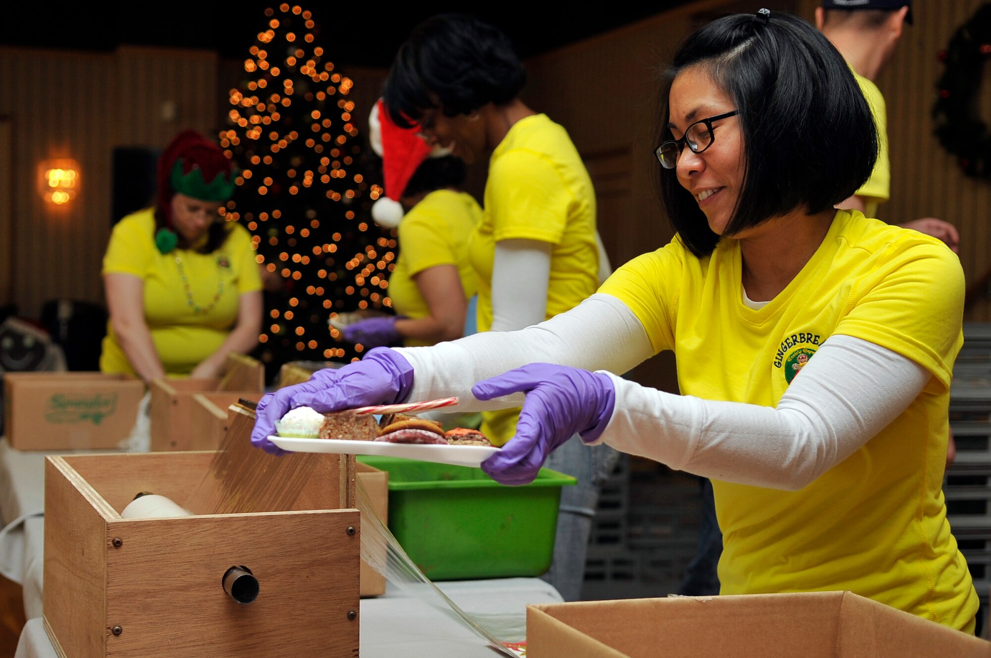 U.S. Air Force Tech. Sgt. Kat Cruz, 35th Medical Operations Squadron and Cookie Caper volunteer, prepares to package a tray of cookies during the Misawa Cookie Caper at Misawa Air Base, Japan, Dec. 11, 2013. The purpose of this annual event is to provide care and a sense of family to the single and unaccompanied service members who are not able to spend the holiday season with their families. (U.S. Air Force photo by Airman 1st Class Zachary Kee)