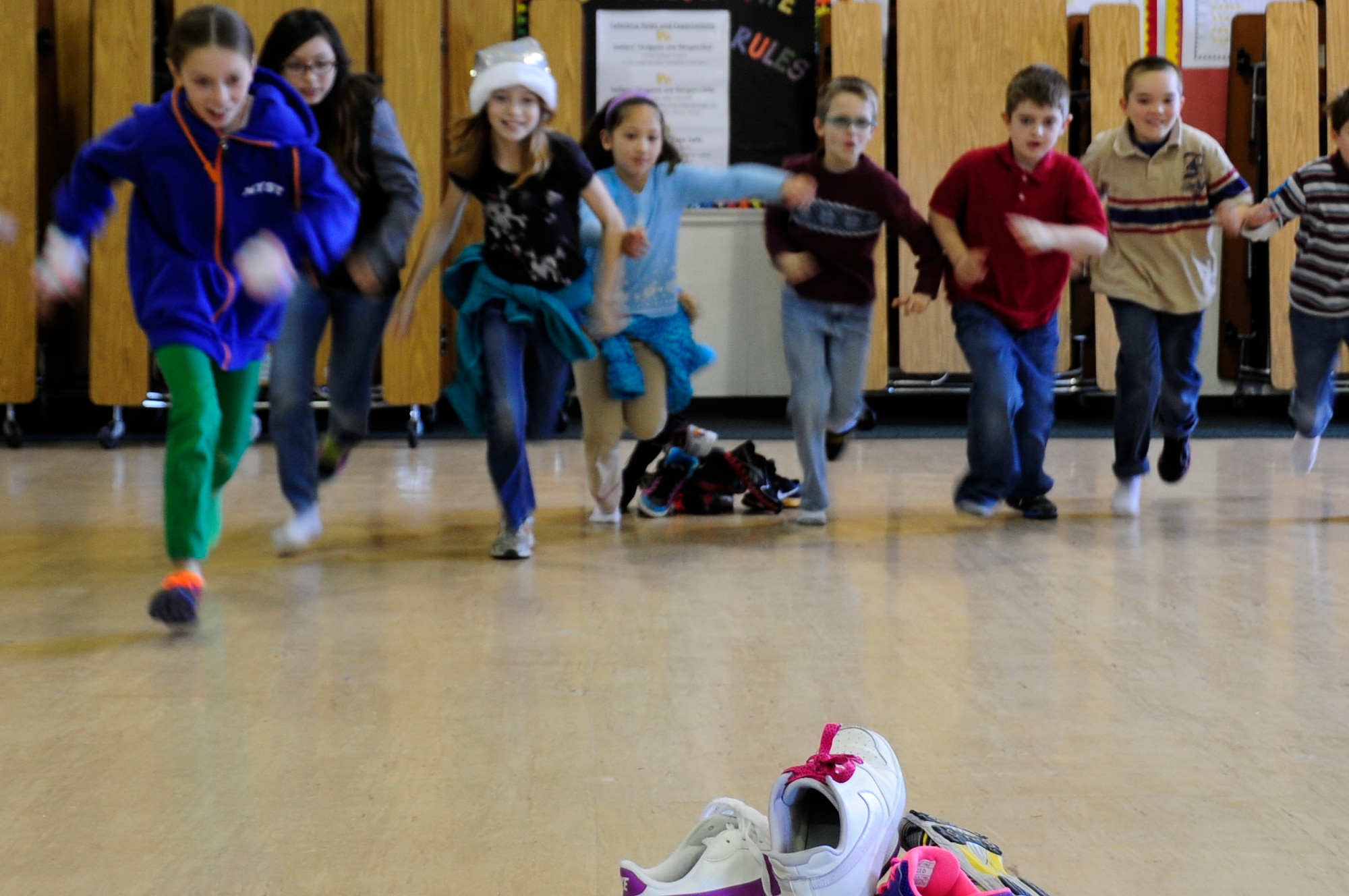 Sollars Elementary students run toward a pile of shoes during the 21st Annual Bilateral Cultural Gift Exchange on Misawa Air Base, Japan, Dec. 7, 2013. This was one of many games that were played during the exchange to help the American and Japanese children meet each other. (U.S. Air Force photo by Tech. Sgt. April Quintanilla)