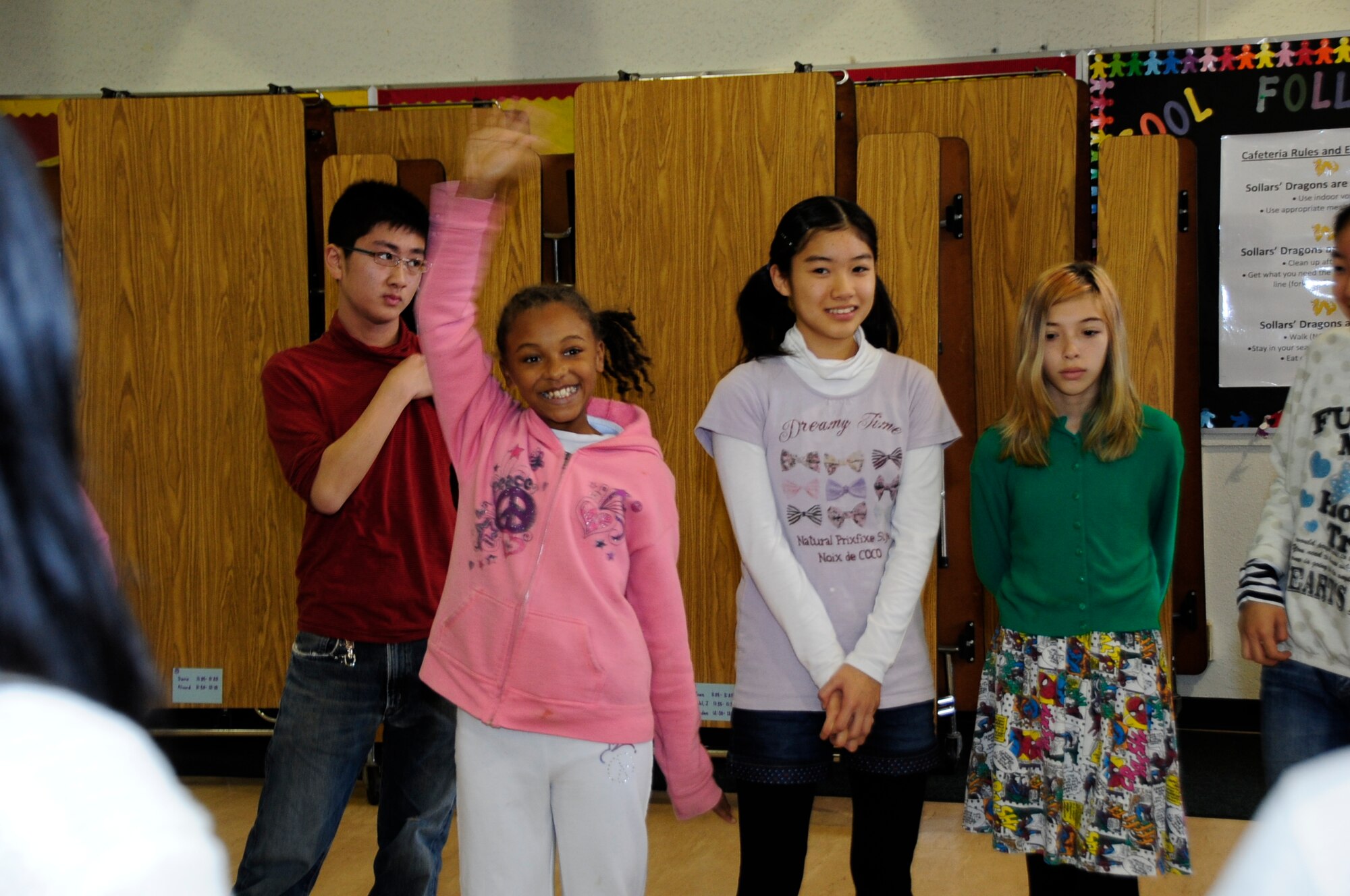 Sollars Elementary students introduce themselves to local Japanese students during the 21st Annual Bilateral Cultural Gift Exchange on Misawa Air Base, Japan, Dec. 7, 2013. The exchange gives American and Japanese children a chance to build relationships and interact with one another. (U.S. Air Force photo by Tech Sgt. April Quintanilla)