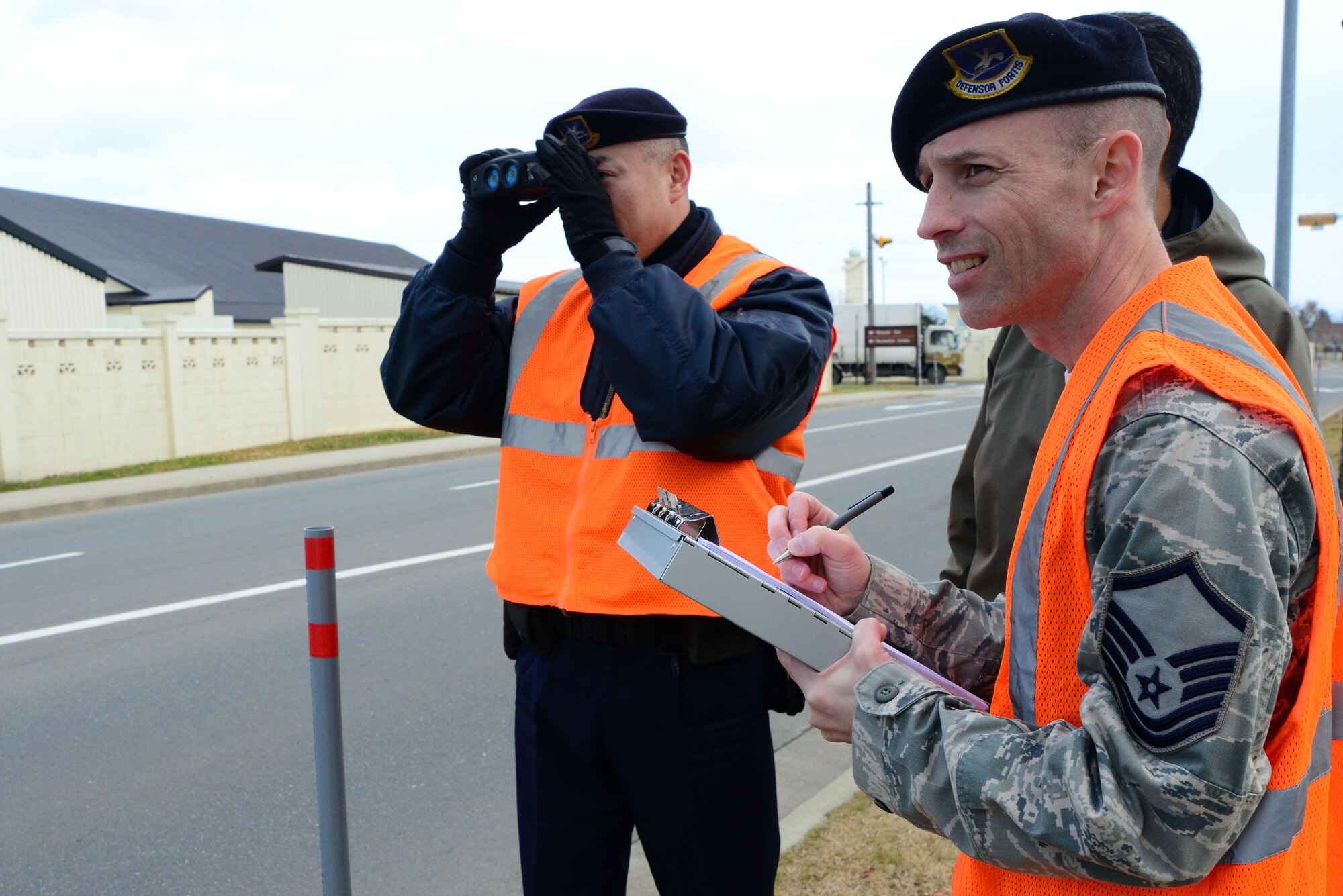 U.S. Air Force Master Sgt. William Newcomb, right, 35th Security Forces Squadron training manager, certifies Katsuyoshi Noguchi, a Japanese national civilian guard, on a light detection and ranging speed measuring device at Misawa Air Base, Japan, Dec. 11, 2013. Members of the 35 SFS are working to certify 20 Japanese national civilian guards on the LIDAR device, which uses light detection and ranging to detect speeding vehicles. (U.S. Air Force photo by Senior Airman Derek VanHorn) 