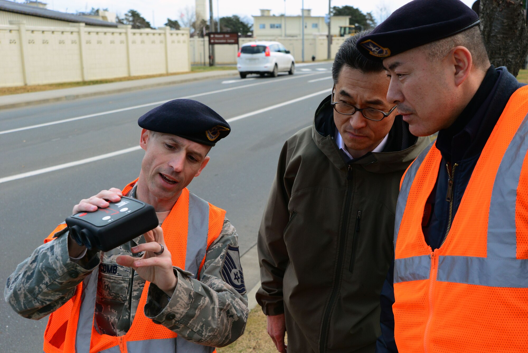 Master Sgt. William Newcomb, 35th Security Forces training manager, explains the functions of a light detection and ranging speed measuring device to Katsuyoshi Noguchi, a Japanese national civilian guard at Misawa Air Base, Japan, Dec. 11, 2013. Members of the 35 SFS are in the process of certifying 20 Japanese national civilian guards on LIDAR devices, which use light detection and ranging to detect speeding vehicles on the base. (U.S. Air Force photo by Senior Airman Derek VanHorn)