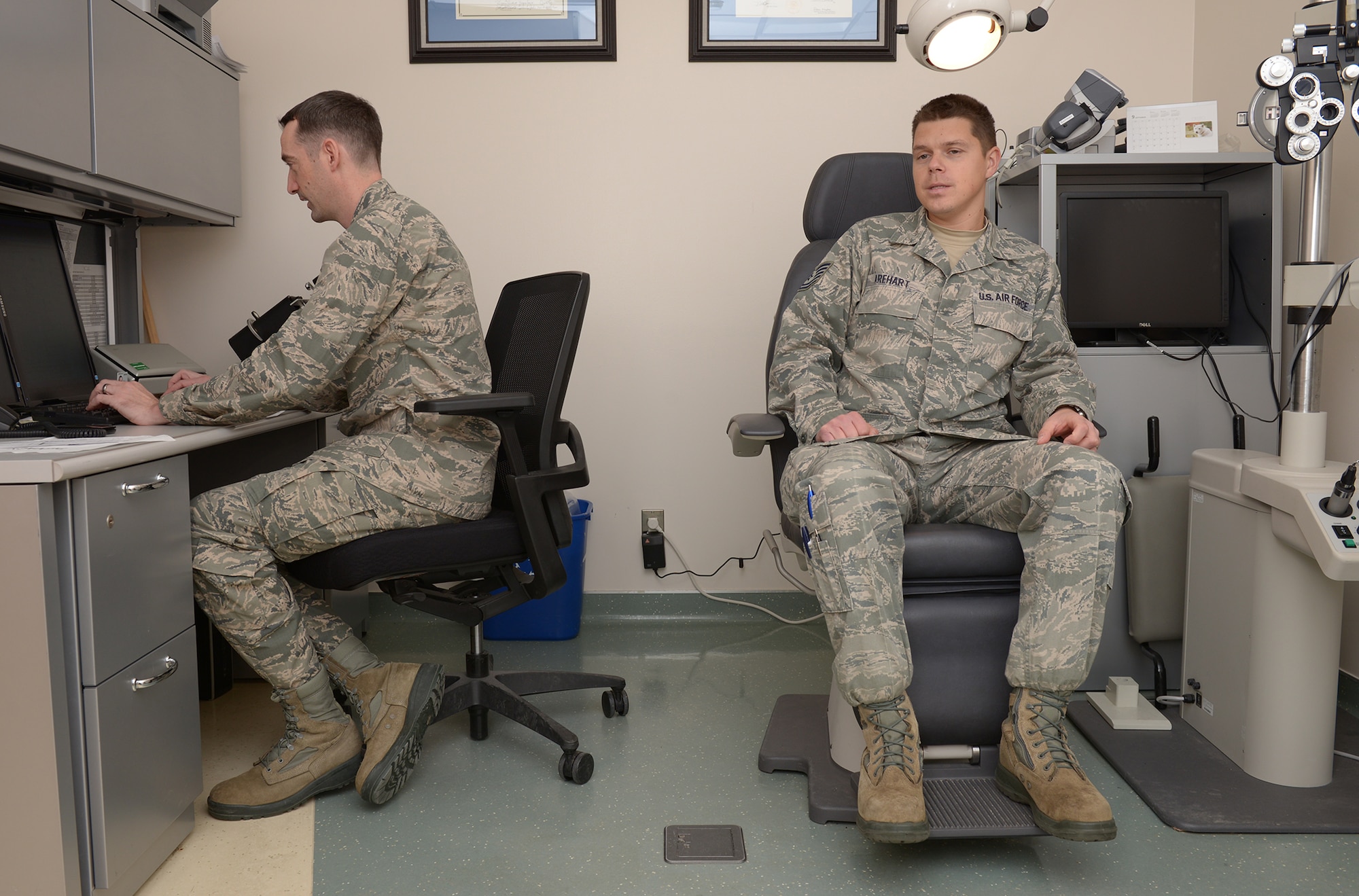 Tech. Sgt. Shawn Arehart, 730th Air Mobility Squadron communication navigation maintainer, describes symptoms to Capt. Benjamin Kolle, 374th Aerospace Medicine Squadron staff optometrist, at Yokota Air Base, Japan, Dec. 11, 2013. Symptoms such as headaches and blurred vision are usually a result of focusing difficulties. (U.S. Air Force photo by Airman 1st Class David Danford/Released)