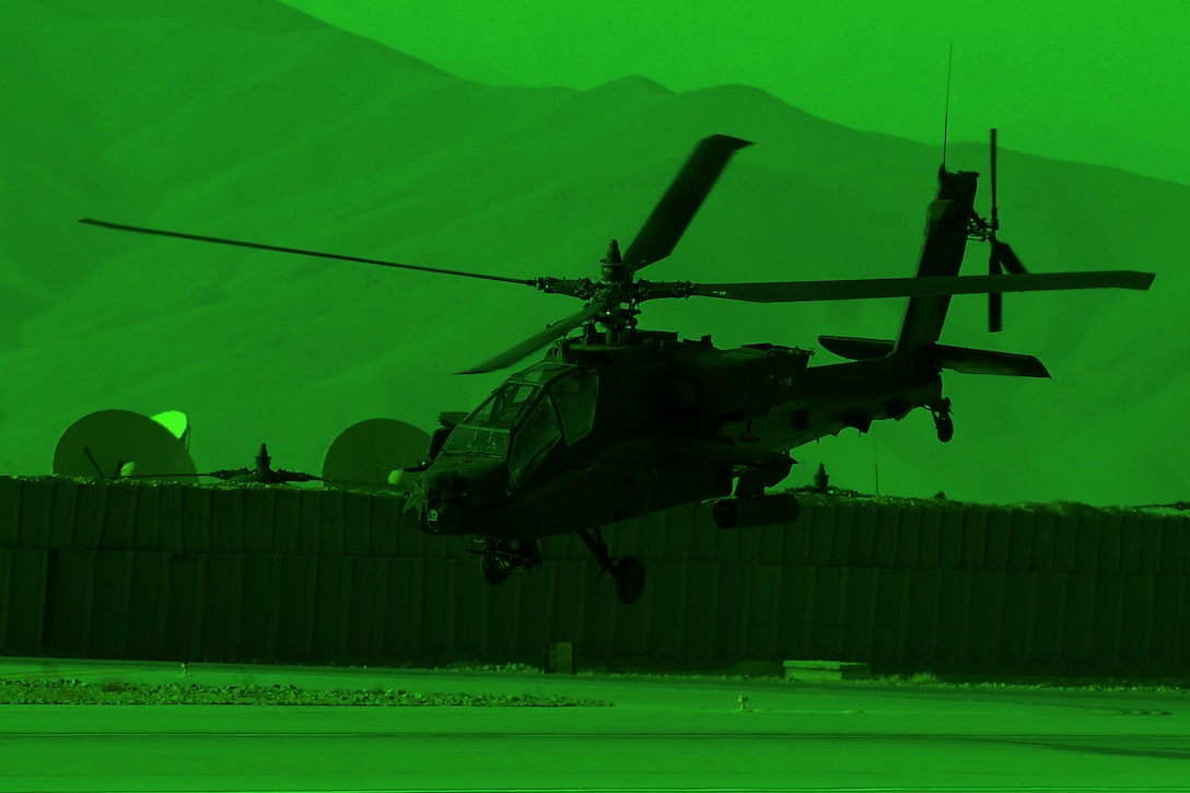 As seen through a night-vision device, a U.S. Army AH-64 Apache helicopter departs Forward Operating Base Shank to conduct a security and reconnaissance mission over Logar province, Afghanistan, Dec. 4, 2013. The helicopter crew is assigned to the 2nd Battalion Assault, 10th Combat Aviation Brigade.