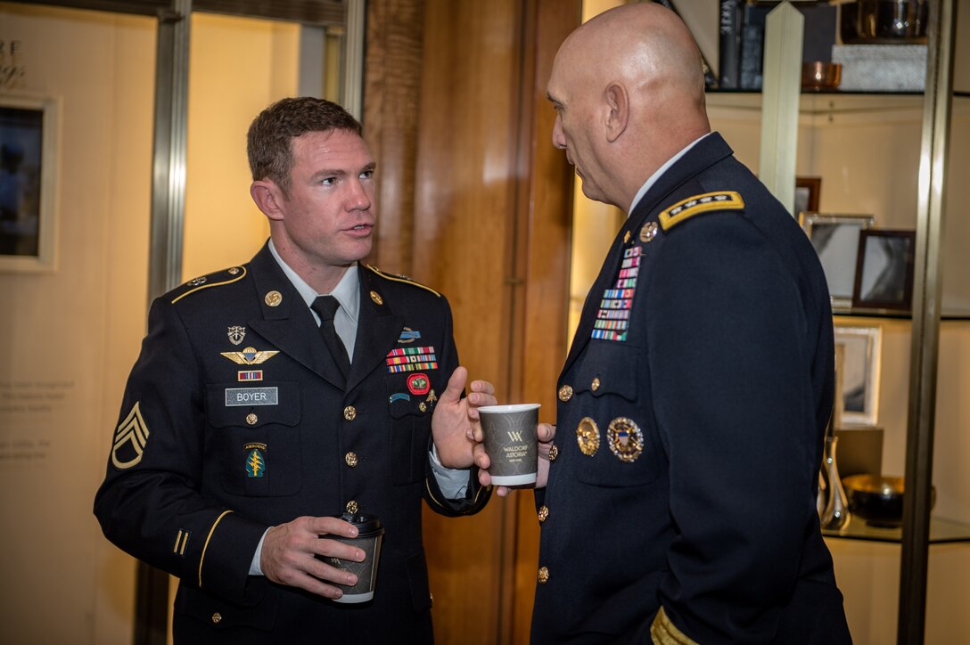 Army Chief of Staff Gen. Ray Odierno speaks with Army Staff Sgt. Nate Boyer before the National Football Foundation press conference, at the Waldorf Astoria Hotel in New York, Dec. 10, 2013. 