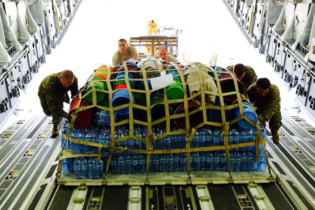 U.S. Marines with Special-Purpose Marine Air-Ground Task Force Africa 13 and U.S. Air Force airmen load a pallet onto a C-17 Globemaster Dec. 12, 2013, in Bujumbura, Burundi. The Marines of Special-Purpose MAGTF Africa 13 provided logistical support to the Burundi National Defense Force as it prepared to join the African Union mission in the Central African Republic.