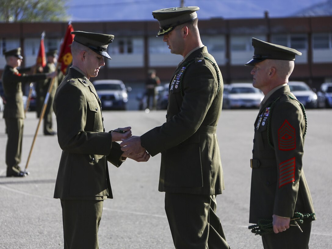 U.S. Marine Corps Lt. Col. Robert Sweiler, 2nd Battalion commanding officer, presents his company commanders with the French Fourragere aboard Camp Pendleton, Calif., Dec. 11, 2013.The 5th and 6th Marine Regiments are authorized to wear the fourragere for heroic actions in World War I. (U.S. Marine Corps photo by Lance Cpl. Akeel Austin, 1st Marine Division Combat Camera/Released)
