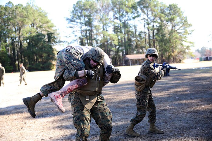 Service members with 2nd Medical Battalion, Combat Logistics Regiment 25, 2nd Marine Logistics Group work together to evacuate a simulated casualty to safety during an exercise aboard Camp Lejeune, N.C., Dec 12, 2013. The mass casualty exercise prepared Marines and sailors for scenarios they may encounter when they deploy. (U.S. Marine Corps photo by Lance Cpl. Shawn Valosin)
