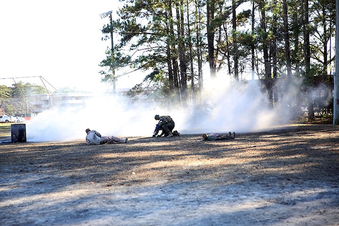 A corpsman with 2nd Medical Battalion, Combat Logistics Regiment 25, 2nd Marine Logistics Group assesses a simulated casualty’s wounds during a mass casualty exercise aboard Camp Lejeune, N.C., Dec 12, 2013. The exercise was held to maintain mission readiness and prepare Marines and sailors  for future deployments.  (U.S. Marine Corps photo by Lance Cpl. Shawn Valosin)
