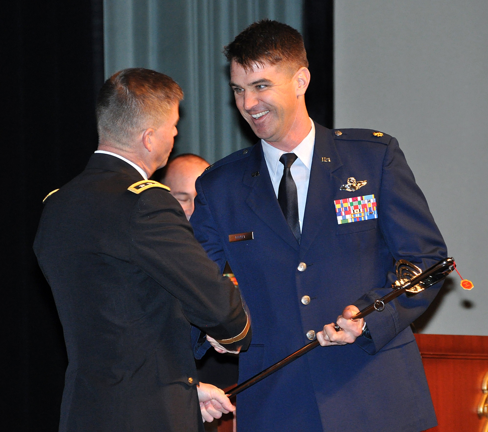 Amry Lt. Gen. David Perkins congratulates Maj. Jason Earley as he is recognized for receiving several Command and General Staff College awards Dec. 13, 2013 during graduation for the 2013-02 Command and General Staff Officer Course at the Lewis and Clark Center at Fort Leavenworth, Kan. Earley was recognized as the class's top U.S. graduate with the General George C. Marshall Award, as the Distinguished Master Tactician with the General George S. Patton Jr. Master Tactician Award, and as the student who best exemplifies the highest qualities of a member of the profession of arms with the Arter-Doniphan Award. Perkins is the Command and General Staff College Commandant and Combined Arms Center and the Fort Leavenworth Commander. (Photo by Prudence Siebert/Fort Leavenworth Lamp)