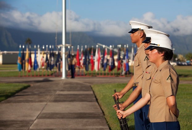 The rifle detail stands at parade rest as service members and civilians gather to remember the attacks on Naval Station Pearl Harbor and Naval Air Station Kaneohe Bay during the Kaneohe Klipper Memorial Ceremony at the base flagpole, Dec. 6, 2013. (U.S. Marine Corps photo by Lance Cpl. Suzanna Knotts)