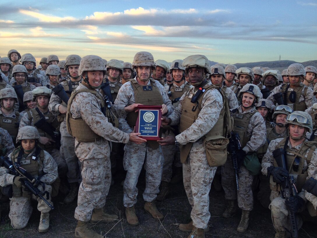 Brigadier Gen. Vincent A. Coglianese, commanding general, 1st Marine Logistics Group, poses for a photo with Marines from 
Combat Logistics Battalion 1, Combat Logistics Regiment 1, 1st MLG, after presenting them the National Defense 
Transportation Association Unit of the Year award during Exercise Steel Knight 14 aboard Camp Pendleton, Calif., Dec. 9. Every year, the NDTA recognizes a military unit that accomplished outstanding service in the field of transportation and logistics during operations. CLB-1 provided exceptional support to Regimental Combat Team 5 and other coalition forces during Operation Enduring Freedom from Oct. 2011 to Dec. 2012.