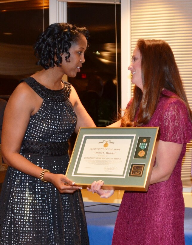 ALBUQUERQUE, N.M., -- Lt. Col. Gant presents ecologist Ondrea Hummel with the Employee of the Year award, Dec. 6, 2013.