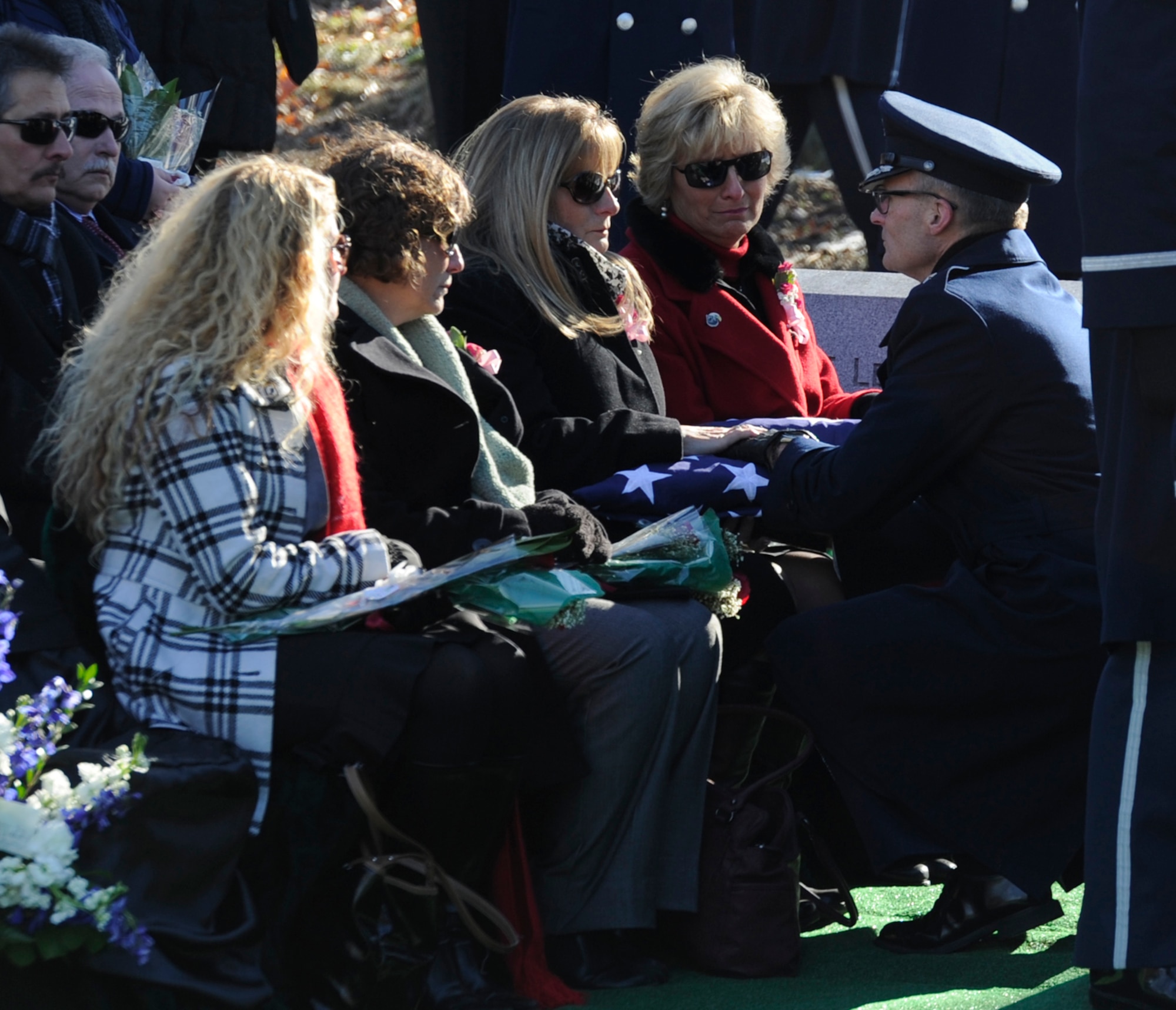 A flag was presented to the family of Col. Francis J. McGouldrick Jr. during his funeral Dec. 13, 2013, at Arlington National Cemetery, Va. McGouldrick was missing in action since 1968 when his plane collided with another plane. His remains were found in a remote jungle in Laos. (U.S. Air Force photo/Airman 1st Class Ryan J. Sonnier)