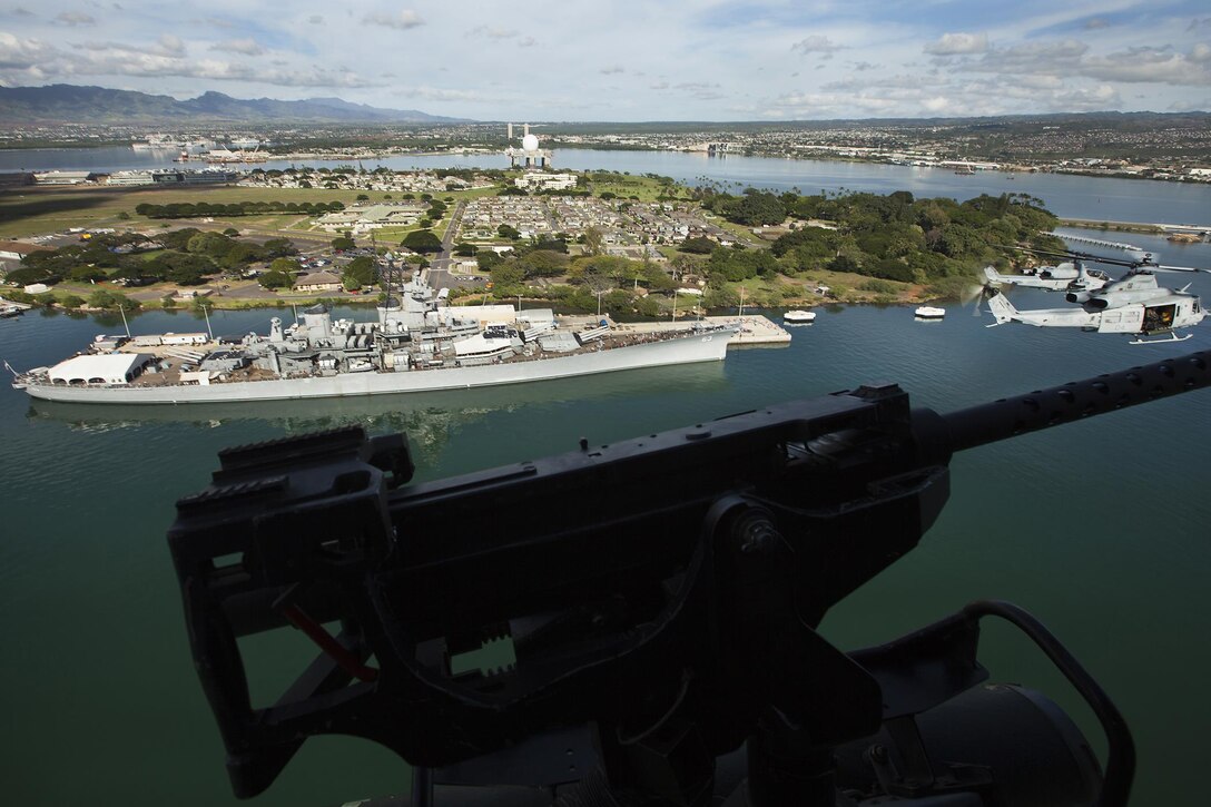 Marine Light Attack Helicopter Squadron 367 flies over the USS Missouri and the USS Arizona Memorial in Pearl Harbor for “Scarface” alumni and other veterans who were present, Dec. 5, 2013. The unit celebrated its 70th anniversary in the Marine Corps, Dec 1., and flew four AH-1W Super Cobra and UH-1Y Huey helicopters over Pearl Harbor to commemorate its history. (U.S. Marine Corps photo by Lance Cpl. Matthew Bragg)