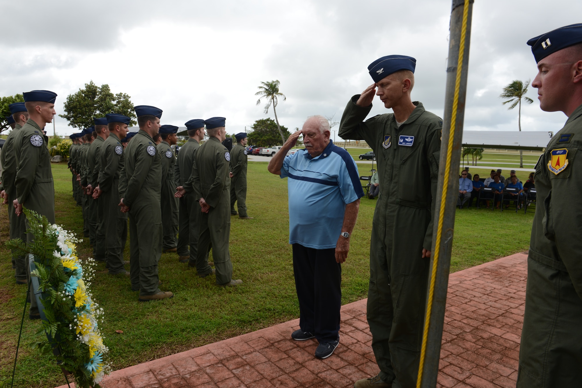 Retired Lt. Col. Charles "Chuck" McManus and Col. Reid Langdon, 36th Operations Group commander, render salutes after laying a wreath at the Linebacker II ceremony Dec. 13, 2013, on Andersen Air Force Base, Guam. The ceremony honored the sacrifices the service members made and observed the 41st year of Operation Linebacker II, which led to the end of the Vietnam War. (U.S. Air Force photo by Airman 1st Class Emily A. Bradley/Released)
