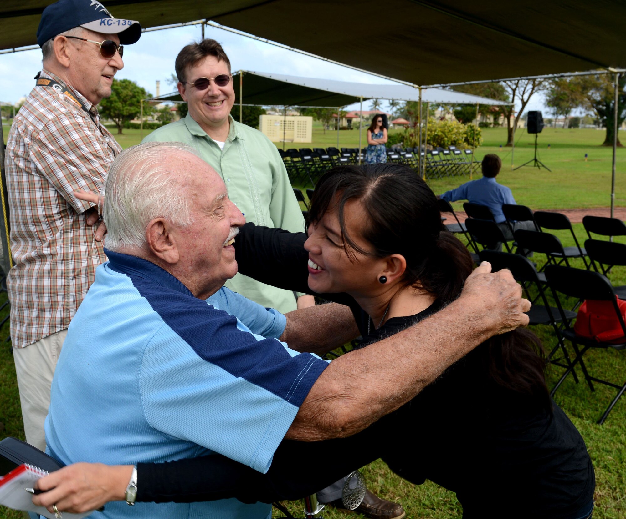 Retired Lt. Col. Charles "Chuck" McManus hugs an attendee prior to the Linebacker II ceremony Dec. 13, 2013, on Andersen Air Force Base, Guam. McMamus was a B-52 Stratofortess navigator during Operation Linebacker II. (U.S. Air Force photo by Airman 1st Class Emily A. Bradley/Released)