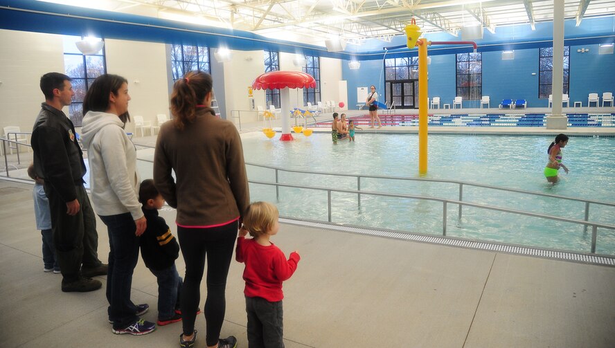 Members from Team Whiteman celebrate the opening of the new Balfour Beatty Communities multi-facility Dec. 13, 2013, at Whiteman Air Force Base, Mo. The 108,000-gallon indoor swimming pool is just one of many amenities now available to residents of base housing. (U.S. Air Force photo by Staff Sgt. Brigitte N. Brantley/Released)