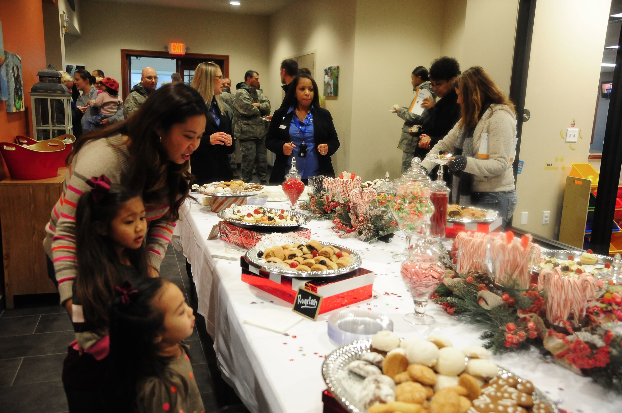 Crystal Vergara, wife of Staff Sgt. Jaime Vergara from the 509th Medical Support Squadron, celebrates with her children at the ribbon-cutting ceremony for the new Balfour Beatty Communities multi-facility Dec. 13, 2013, at Whiteman Air Force Base, Mo. The facility includes a 4,500-square-foot Community Center and 16,000-square-foot Recreation Center. (U.S. Air Force photo by Staff Sgt. Brigitte N. Brantley/Released)