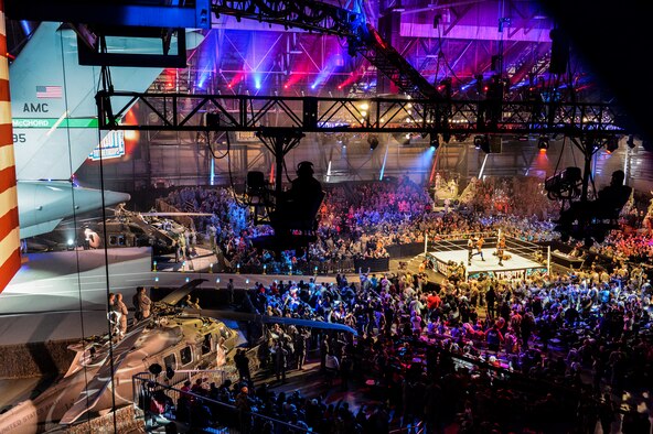 World Wrestling Entertainment production crewmembers sit suspended in lighting rigs, Dec. 11, 2013, during the WWE Tribute to the Troops event at Joint Base Lewis-McChord, Wash. Crews transformed a hangar at McChord Field into a wrestling arena which sat 4,000 and was surrounded with various military vehicles and aircraft. (U.S. Air Force photo/Tech. Sgt. Sean Tobin)
