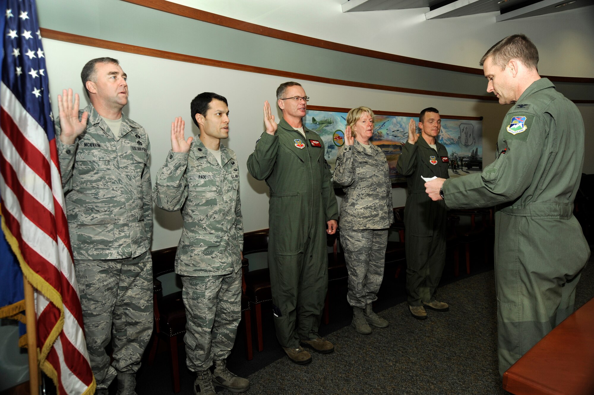 Col. Rick Wedan, 142nd Fighter Wing Commander, (right) administers the oath to the new Wing assessment and management team that will help conduct inspections using the Management Internal Control Toolsets (MICT), Dec. 3, 2013 at the Portland Air National Guard Base, Ore. Members include (Left to right) Chief Master Sgt. John McIlvain, Lt. Col. Frank Page, Lt. Col. Bill Kopp, Senior Master Sgt. Linda Baugher and Lt. Col. Sean Sullivan.  (Air National Guard photo by Tech. Sgt. John Hughel, 142nd Fighter Wing Public Affairs/Released)