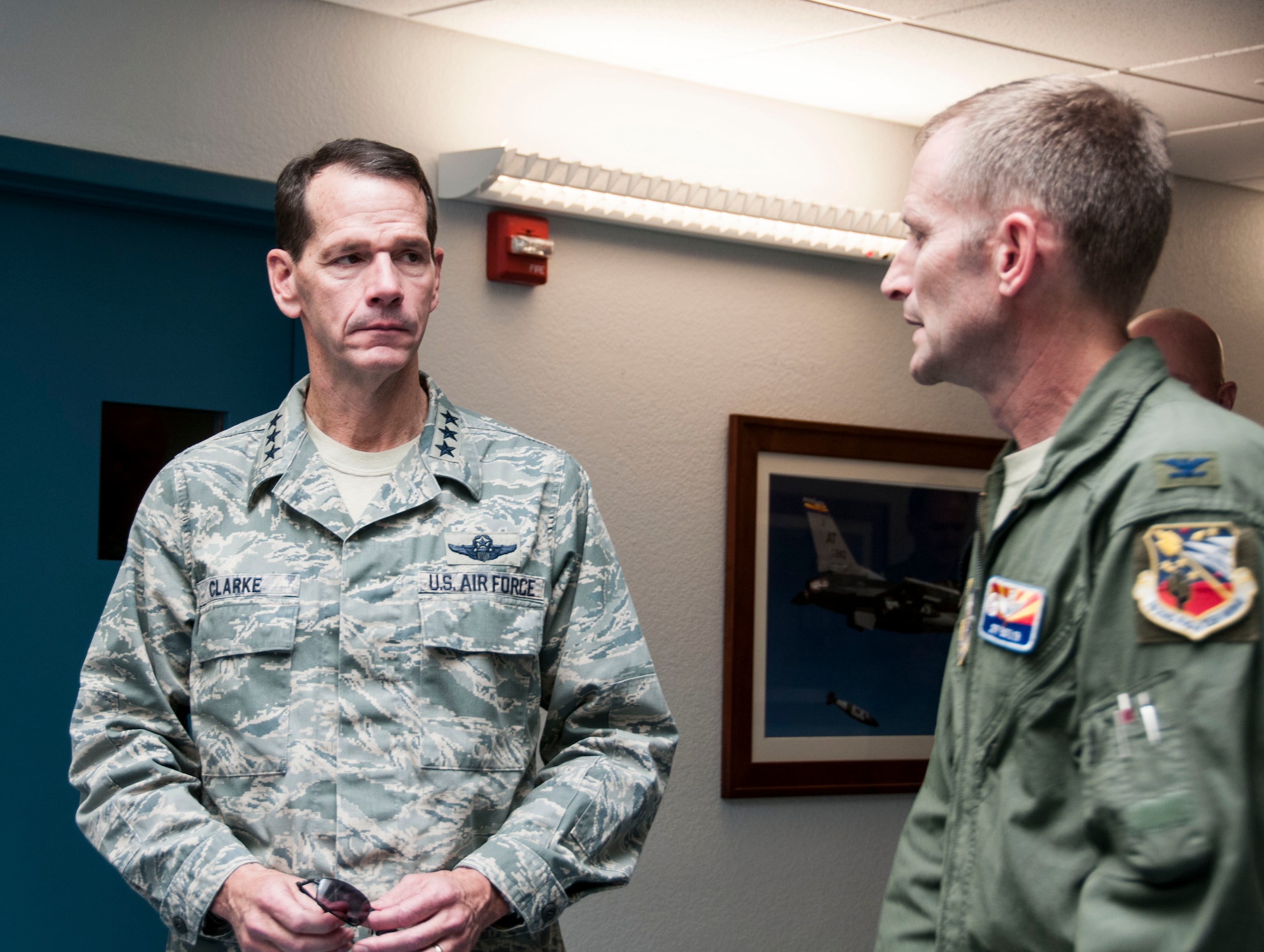 Lt. Gen. Stanley E. Clarke III, director of the Air National Guard, speaks with Col. Jeffery Butler, commander of the 162nd Operations Group at the 162nd Fighter Wing in Tucson, Ariz., Dec. 13, 2013.  The visit is Clarke's first to the Arizona Air Guard since becoming director. During the visit, Clarke met with Airmen from 162nd Fighter and the 214th Reconnaissance Group. (U.S. Air National Guard photo by Staff Sgt. Dina Farmer/Released)