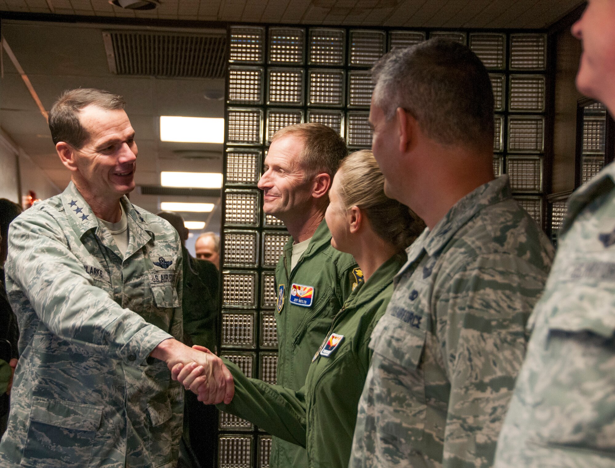 Lt. Gen. Stanley E. Clarke III, director of the Air National Guard, greets the leadership of the 162nd Fighter Wing, during a visit to Tucson, Ariz., Dec. 13, 2013. The visit is Clarke's first to the Arizona Air Guard since becoming director. During the visit, Clarke met with Airmen from 162nd Fighter and the 214th Reconnaissance Group. (U.S. Air National Guard photo by Staff Sgt. Dina Farmer/Released)
