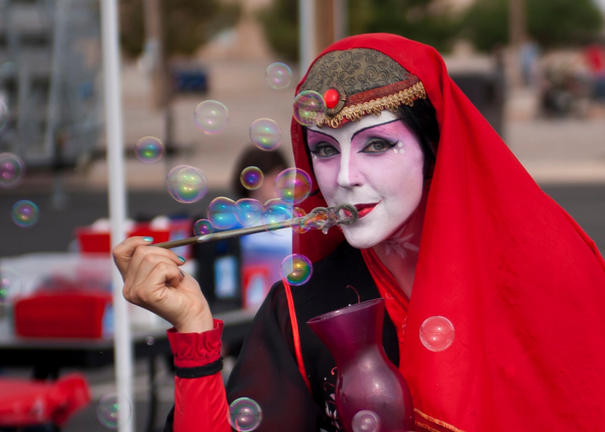 A member of the Clan Tynker performance group blows bubbles during the Freedom Fest Independence Day celebration at Holloman Air Force Base, N.M., July 3. Freedom Fest took place at the Domenici Fitness and Sports Center parking lot and included carnival games, rides, and live music for Airmen and their families. (U.S. Air Force photo by Airman 1st Class Aaron Montoya/Released)