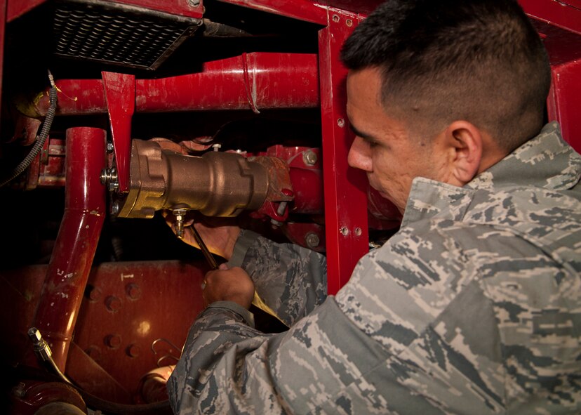 Staff Sgt. Enrique Soriano, 49th Logistics Readiness Squadron non-commissioned officer in charge of fire truck maintenance fastens a new relief valve on a P-19 fire truck at Holloman Air Force Base, N.M., Dec. 11. Bennett spent the day working hands-on with fire truck mechanics of the 49th LRS to get an insight of their daily life and connect with the airmen. (U.S. Air Force photo by Airman 1st Class Aaron Montoya/Released)