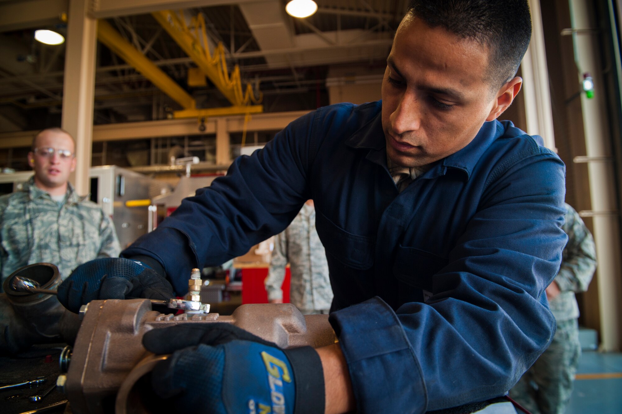 Senior Airman Fabian Garcia, 49th Logistics Readiness Squadron fire truck mechanic, prepares a new relief valve to be installed in a P-19 fire truck at Holloman Air Force Base, N.M., Dec. 11. Bennett spent the day working hands-on with fire truck mechanics of the 49th LRS to get an insight of their daily life and connect with the airmen. (U.S. Air Force photo by Airman 1st Class Aaron Montoya/Released)