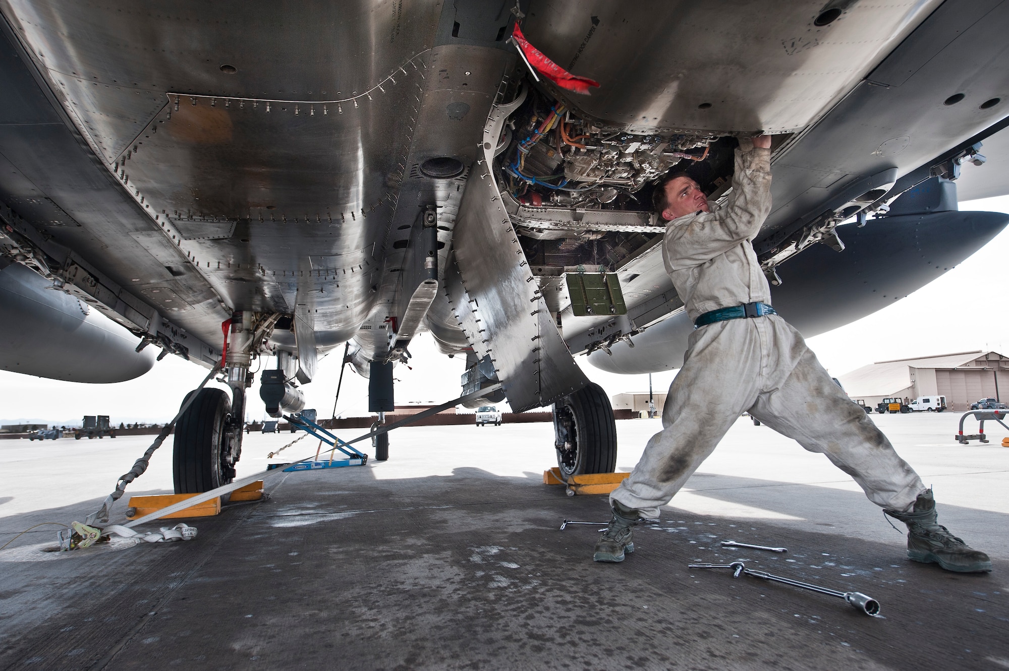 Airman 1st Class Anthony Smith, 48th Aircraft Maintenance Squadron, Royal Air Force Lakenheath, England, crew chief, breaks torque on an F-15C Eagle gearbox at Nellis Air Force Base, Nev. March 5, 2013.  The 48th Fighter Wing is participating in a RED FLAG 13-3, the air-to-air exercise is a realistic combat training environment involving the air forces of the United States and its allies. (U.S. Air Force photo by Lawrence Crespo)