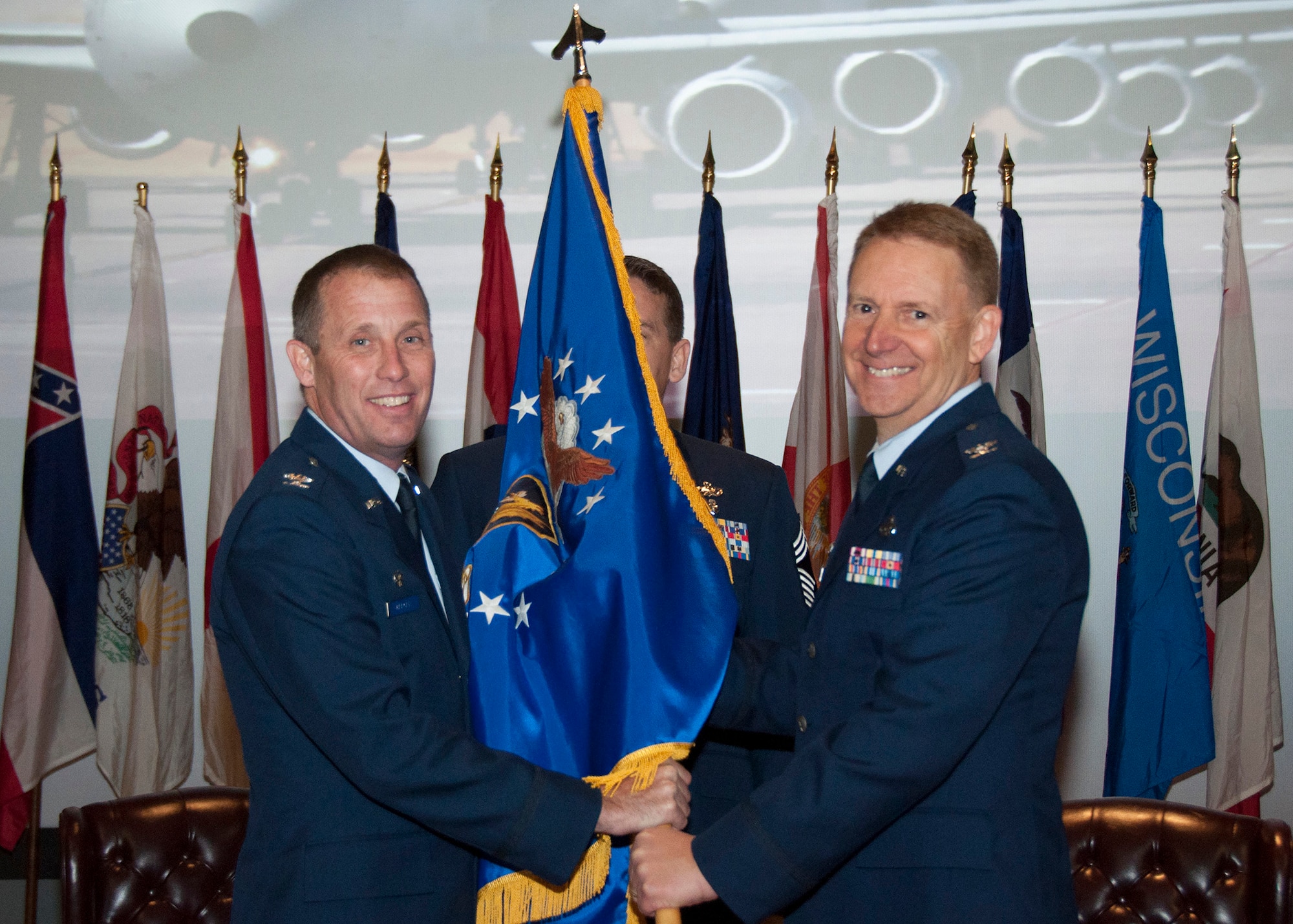 TRAVIS AIR FORCE BASE, Calif. -- Col. Matt Burger, 349th Air Mobility Wing commander, passes the 349th Mission Support Group guidon to Col. Stuart Toft, during an assumption of command ceremony, Dec. 7. (U.S. Air Force photo/Senior Master Sgt. Robert Wade/Released) 