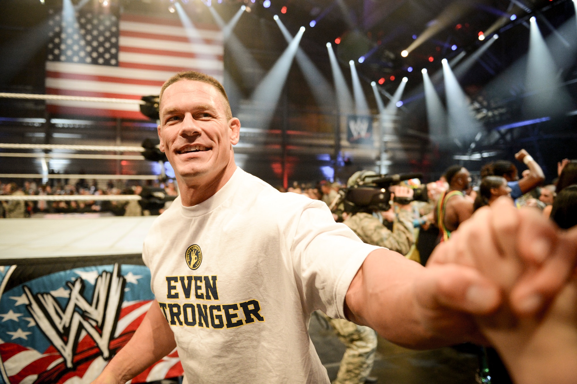 Professional wrestler John Cena shakes hands with a child, Dec. 11, 2013, at the conclusion of the WWE Tribute to the Troops event at Joint Base Lewis-McChord, Wash. The event entertained approximately 4,000 service members and family members stationed throughout  the Puget Sound area. (U.S. Air Force photo/Tech. Sgt. Sean Tobin)