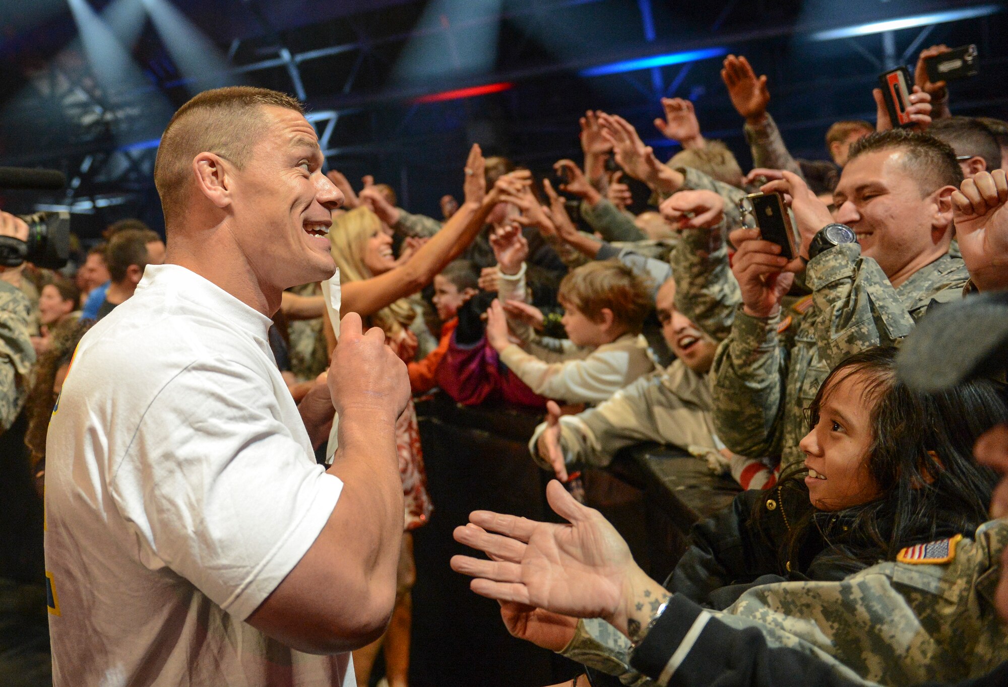 World Wrestling Entertainment superstar John Cena, poses for photos, Dec. 11, 2013, at the conclusion of the WWE Tribute to the Troops event at Joint Base Lewis-McChord, Wash. The event featured wrestling matches by 40 WWE superstars and divas, along with performances by comedian Jeff Dunham and rock band Daughtry. (U.S. Air Force photo/Tech. Sgt. Sean Tobin)