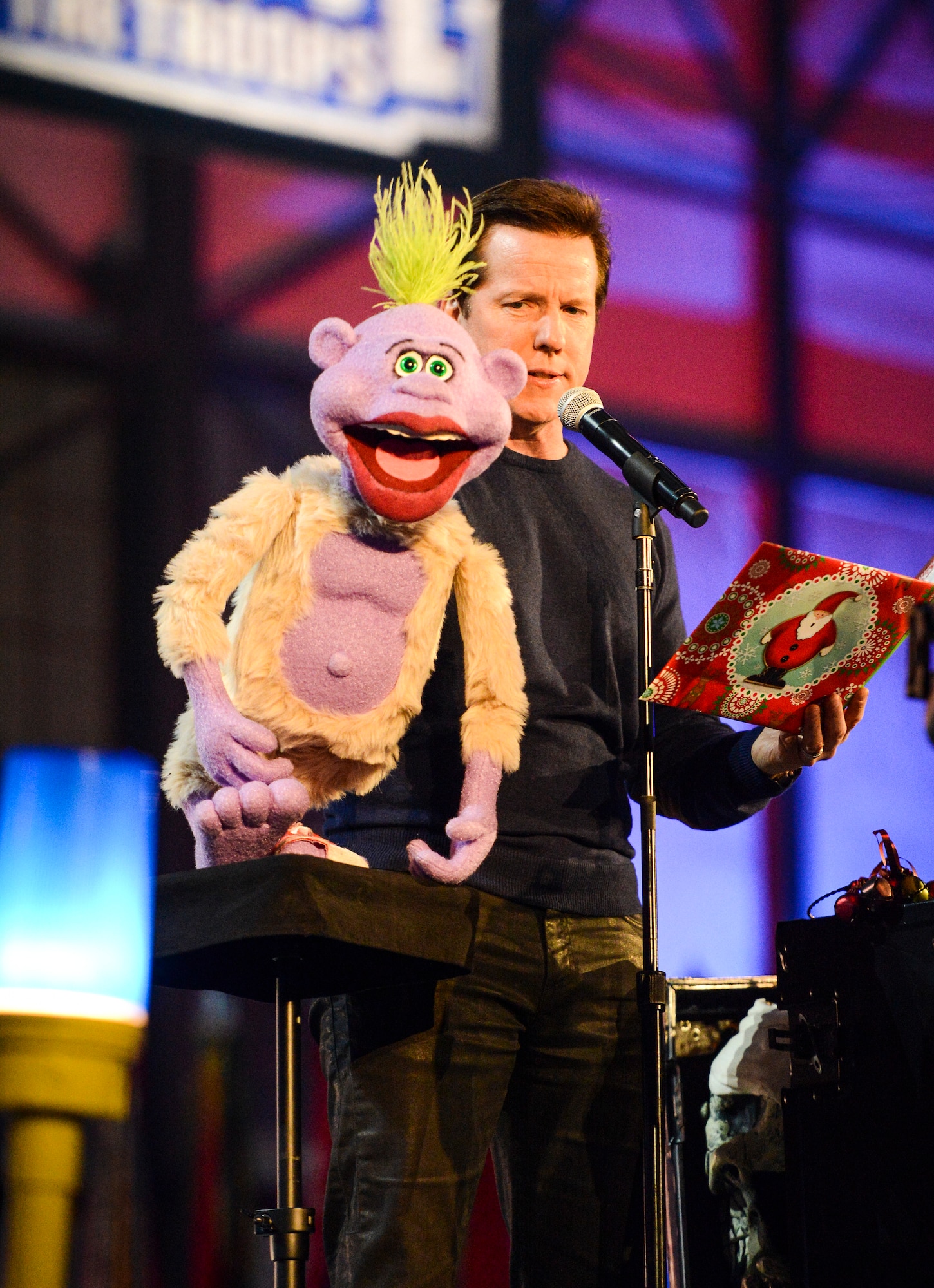 Comedian and ventriloquist Jeff Dunham and his sidekick, Peanut, perform for service members and family members, Dec. 11, 2013, at Joint Base Lewis-McChord, Wash. Dunham's performance was part of the WWE Tribute to the Troops event which entertained approximately 4,000 people. (U.S. Air Force photo/Tech. Sgt. Tobin)