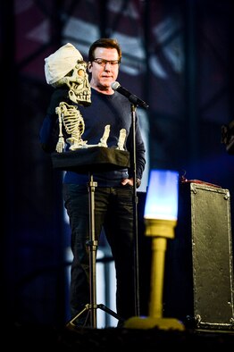 Comedian Jeff Dunham performs Dec. 11, 2013, during the WWE Tribute to the Troops event at Joint Base Lewis-McChord, Wash. Dunham performed his routine between wrestling matches, held at a McChord Field hangar. (U.S. Air Force photo/Tech. Sgt. Sean Tobin)