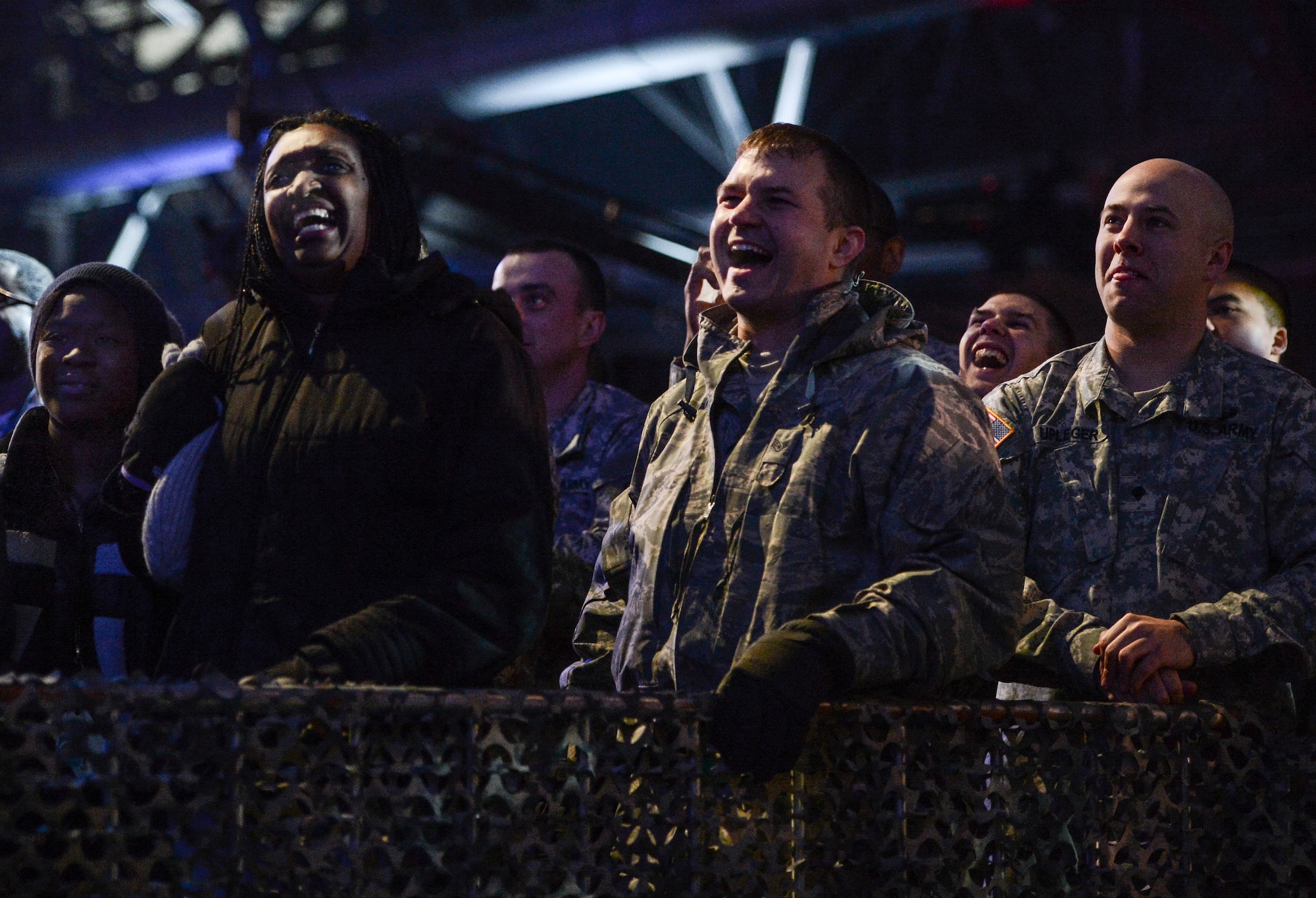 Audience members laugh during a performance by comedian Jeff Dunham, Dec. 11, 2013, at the WWE Tribute to the Troops event at Joint Base Lewis-McChord, Wash. The event took place at a hangar at McChord Field and provided entertainment for 4,000 service members and family members. (U.S. Air Force photo/Tech. Sgt. Sean Tobin)