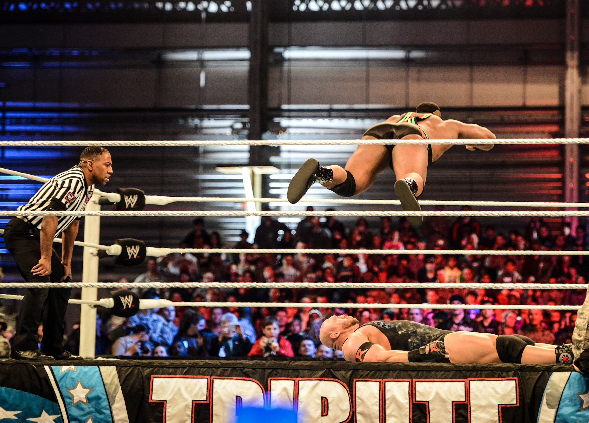 WWE superstar Big E Langston flies high over his opponent Ryback during a wrestling match, Dec. 13, 2013, at Joint Base Lewis-McChord, Wash. The WWE Tribute to the Troops event, which entertained thousands of JBLM service members and family members, featured dozens of WWE superstars and divas and included performances by the rock band Daughtry and comedian Jeff Dunham. (U.S. Air Force photo/Tech. Sgt. Sean Tobin)
