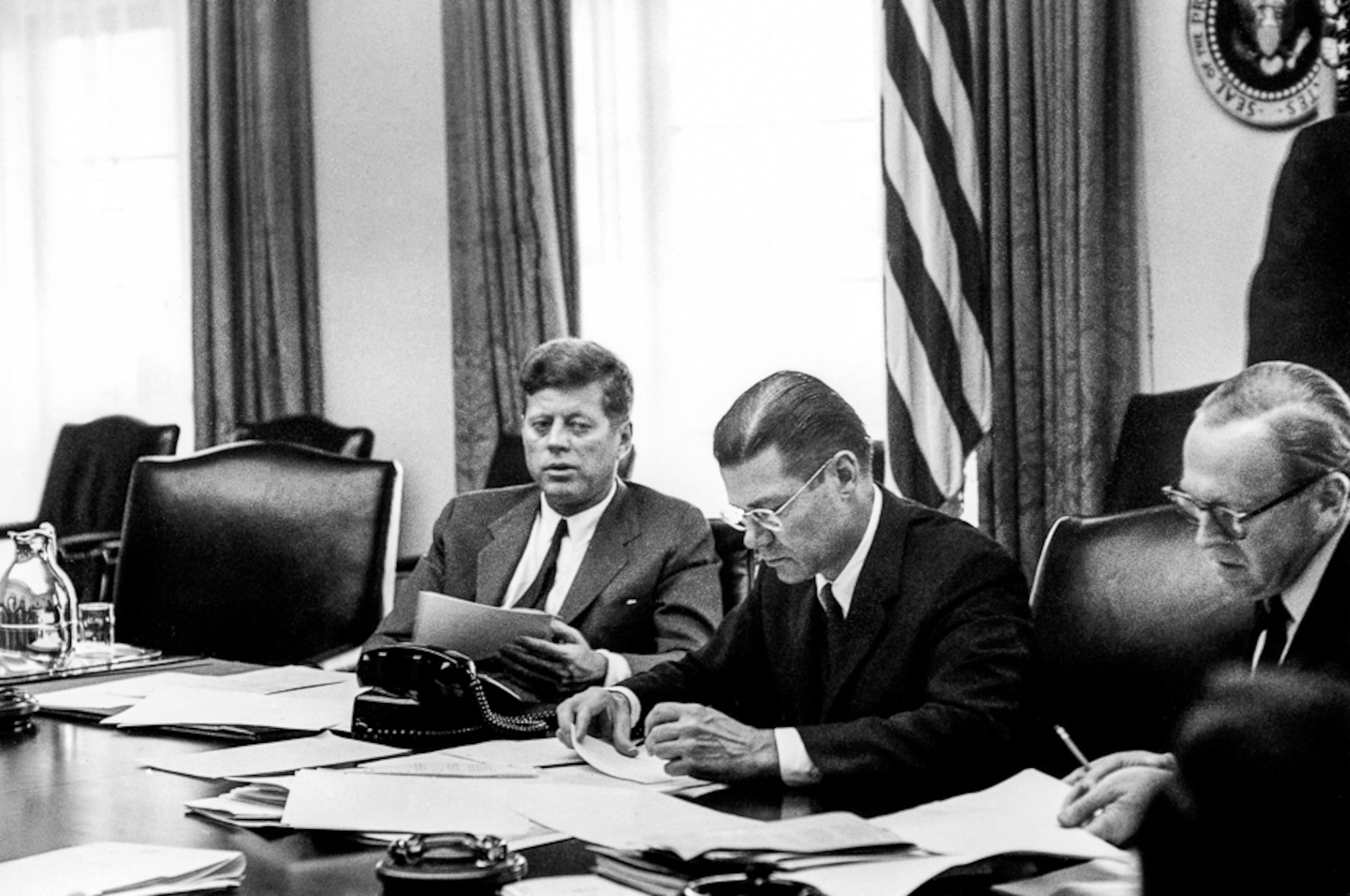 President John F. Kennedy, Secretary of Defense Robert McNamara and Deputy Secretary of Defense Roswell Gilpatric meet Oct. 29, 1962, in the White House’s cabinet room during the Cuban Missile Crisis. (Public Domain)