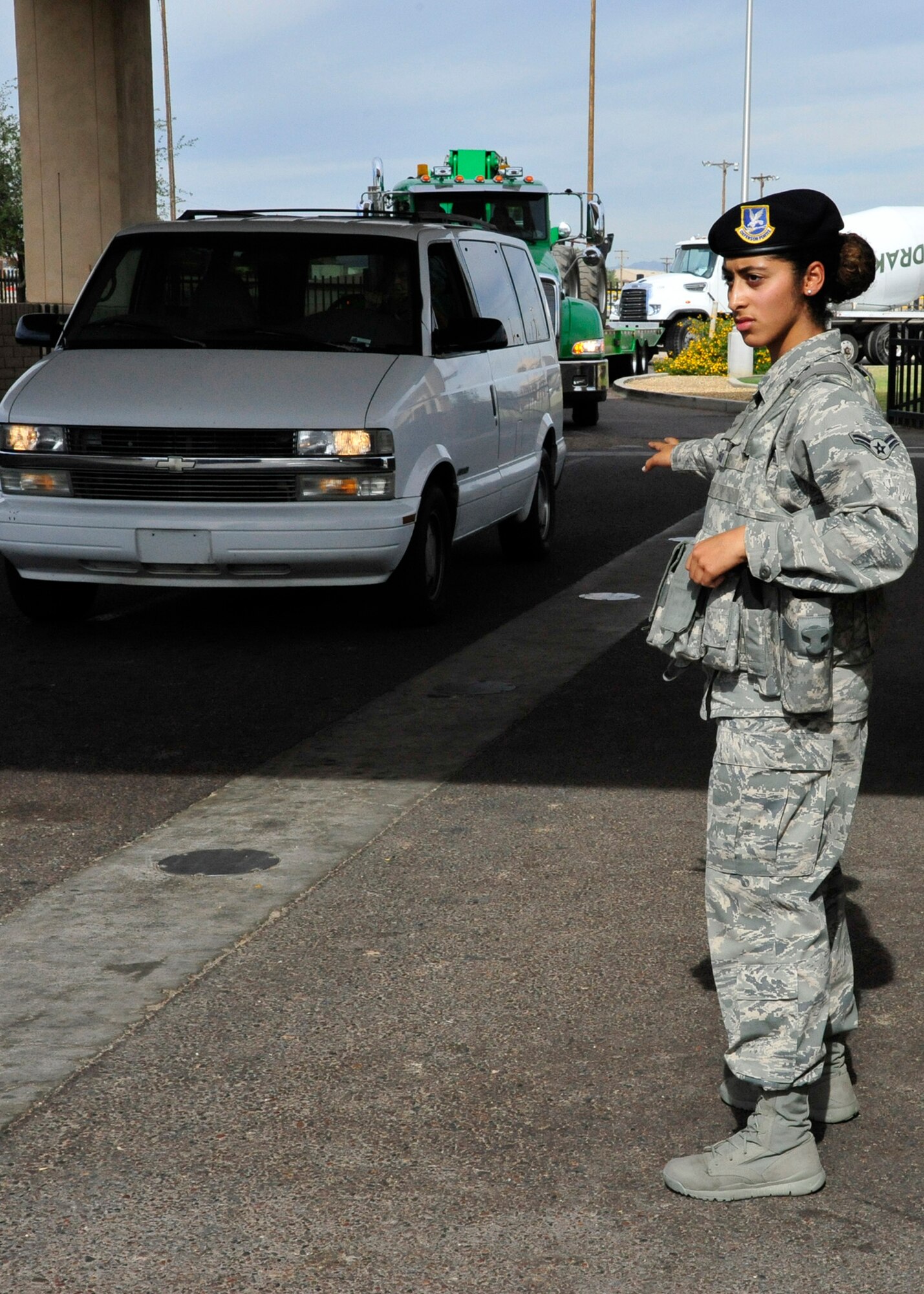 Airman 1st Class Oumaima Lehnoud, 56th Security Forces Squadron security patrol and entry controller, guides a vehicle through the South Gate search pit Nov. 12 on Luke Air Force Base. (U.S. Air Force photo/Senior Airman Grace Lee)