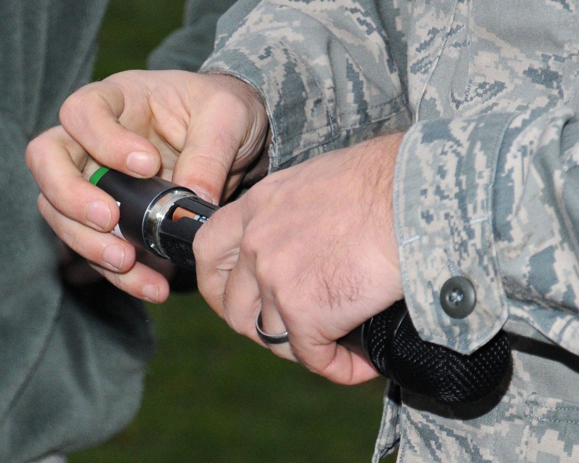 U.S. Air Force Master Sgt. Harry Majewski, 100th Communication Squadron NCO in charge of Radio Frequency Transmission Systems from Warren, Mich., installs batteries for a microphone during the 100th Air Refueling Wing Tree Lighting Ceremony Dec. 6, 2013, on RAF Mildenhall, England. The radio frequency transmissions shop personnel helped set up the public address system for the Christmas tree lighting ceremony. The radio frequency transmission systems work center completes 200 preventive maintenance inspections on 31 pieces of equipment yearly. (U.S. Air Force photo by Gina Randall/Released)