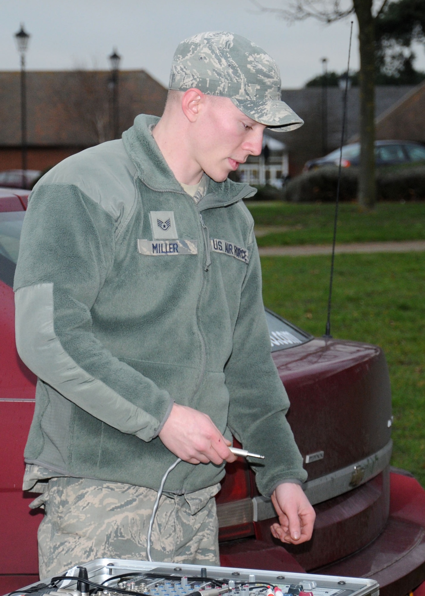 U.S. Air Force Staff Sgt. Joshua Miller, 100th Communication Squadron Radio Frequency Transmission Systems supervisor from Greenville, Ill., troubleshoots an audio connection for a public address setup Dec. 6, 2013, on RAF Mildenhall, England. The radio frequency transmissions shop personnel helped set up the public address system for the Christmas tree lighting ceremony. The radio frequency transmissions shop provides on average of 150 public address setups per year. (U.S. Air Force photo by Gina Randall/Released)