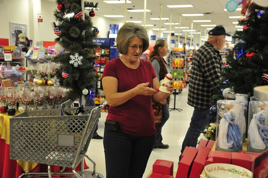 Judy Fuqua, spouse of Rusty Fuqua, retired Navy Chief Petty Officer, looks at Christmas ornaments Monday at the Luke Air Force Base Exchange. The purchase of a fresh tree can help prevent house fires during the holidays. (U.S. Air Force photo/Senior Airman Grace Lee)