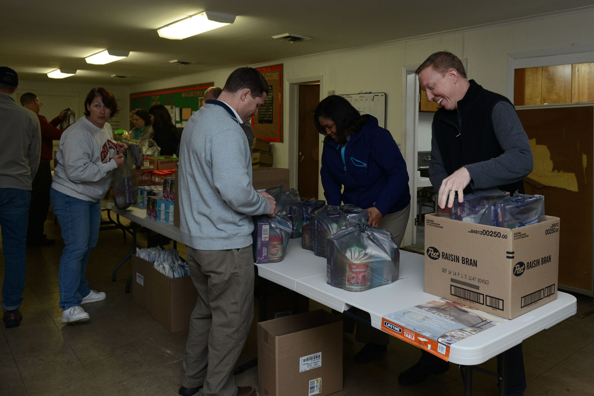 Service members from the Air Land Sea Application Center at Langley Air Force Base worked with the Peninsula Agency on Aging program to build food baskets for local home-bound elderly citizens in Newport News, Va., Dec. 10, 2013. The ALSA is a multi-service organization that helps develop tactical-level solutions of multi-service interoperability issues consistent with the Joint and Service doctrines.  (U.S. Air Force photo by Airman 1st Class Kimberly Nagle/Released)