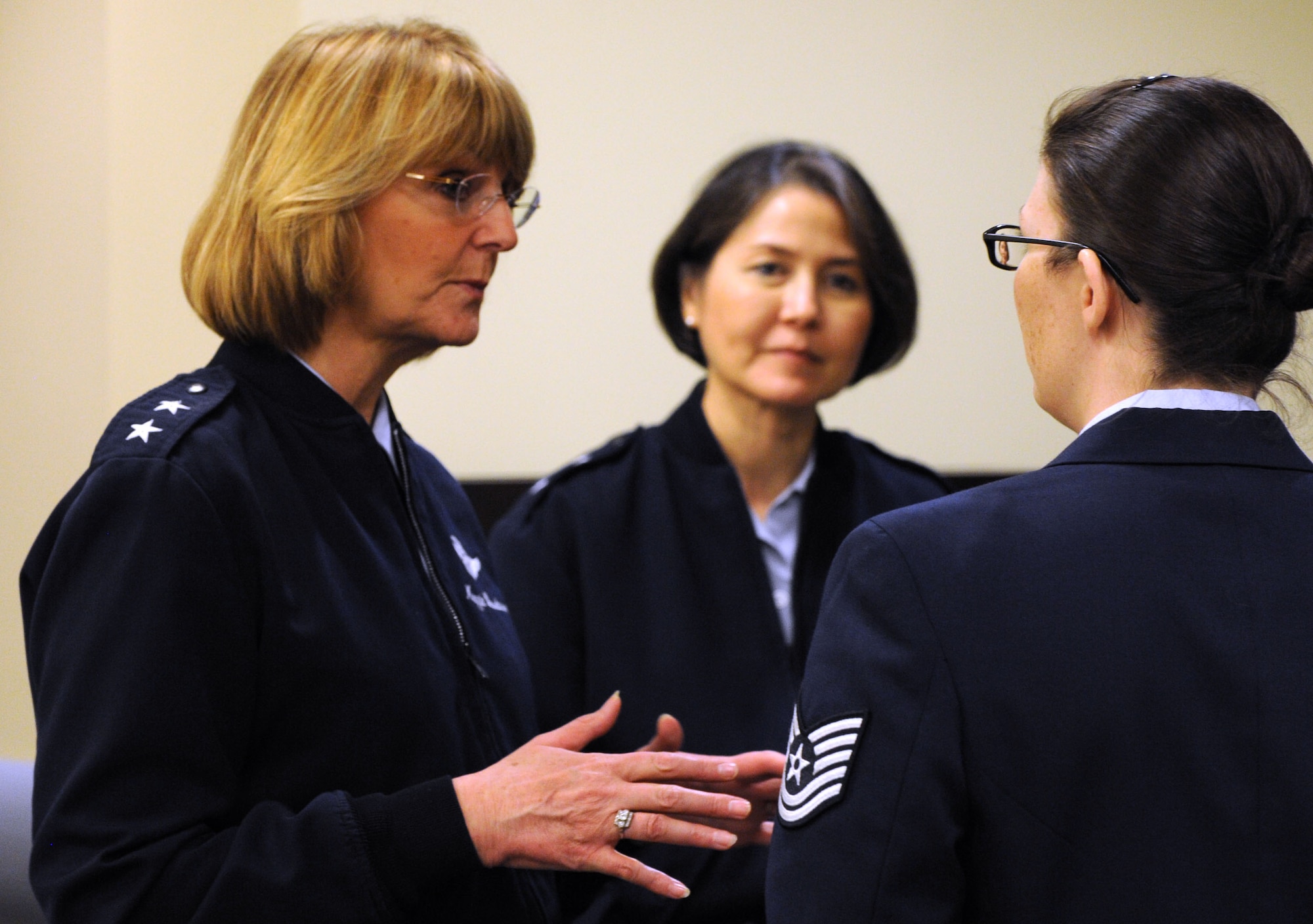 Director of the Air Force Sexual Assault Prevention and Response Office Maj. Gen. Margaret H. Woodward talks with a Capital Airmen Development Seminar attendee and Air Force District of Washington Commander Maj. Gen. Sharon K.G. Dunbar at the General Jacob E. Smart Center on Joint Base Andrews, Md., Dec. 5, 2013. Woodward discussed the service's sexual assault prevention, education, accountability, victim assistance and assessment efforts with seminar attendees. (U.S. Air Force photo/Tech. Sgt. Tammie Moore)